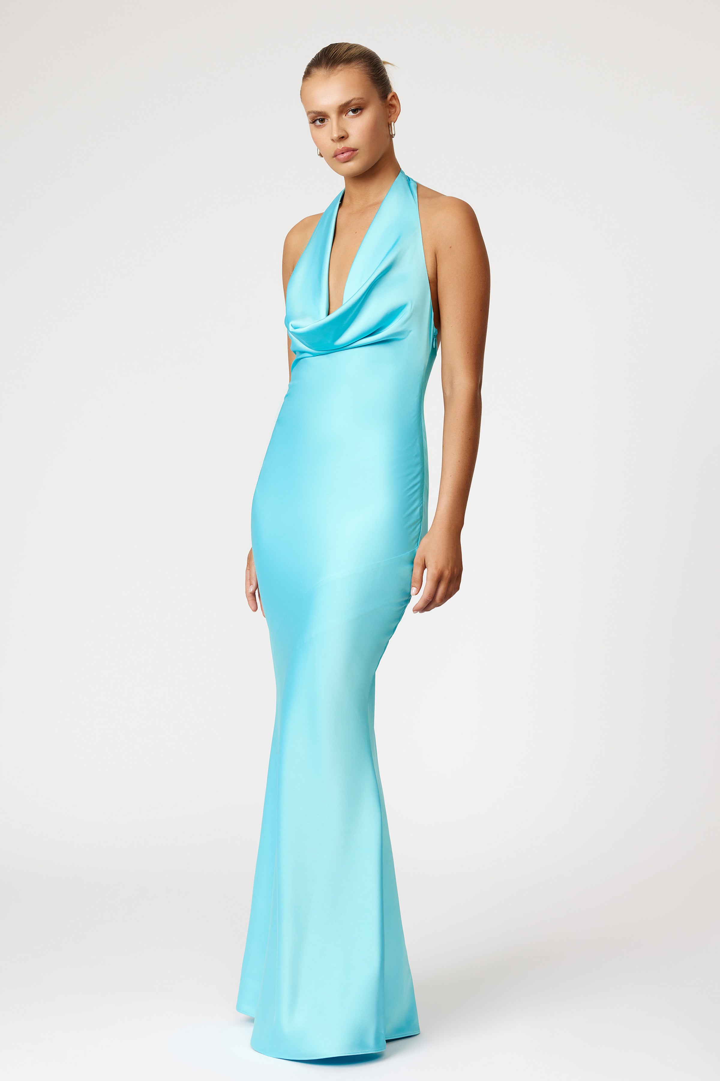 Amalia Dress featuring a sleek halter neckline and fitted silhouette in lagoon blue for formal and wedding guest occasions