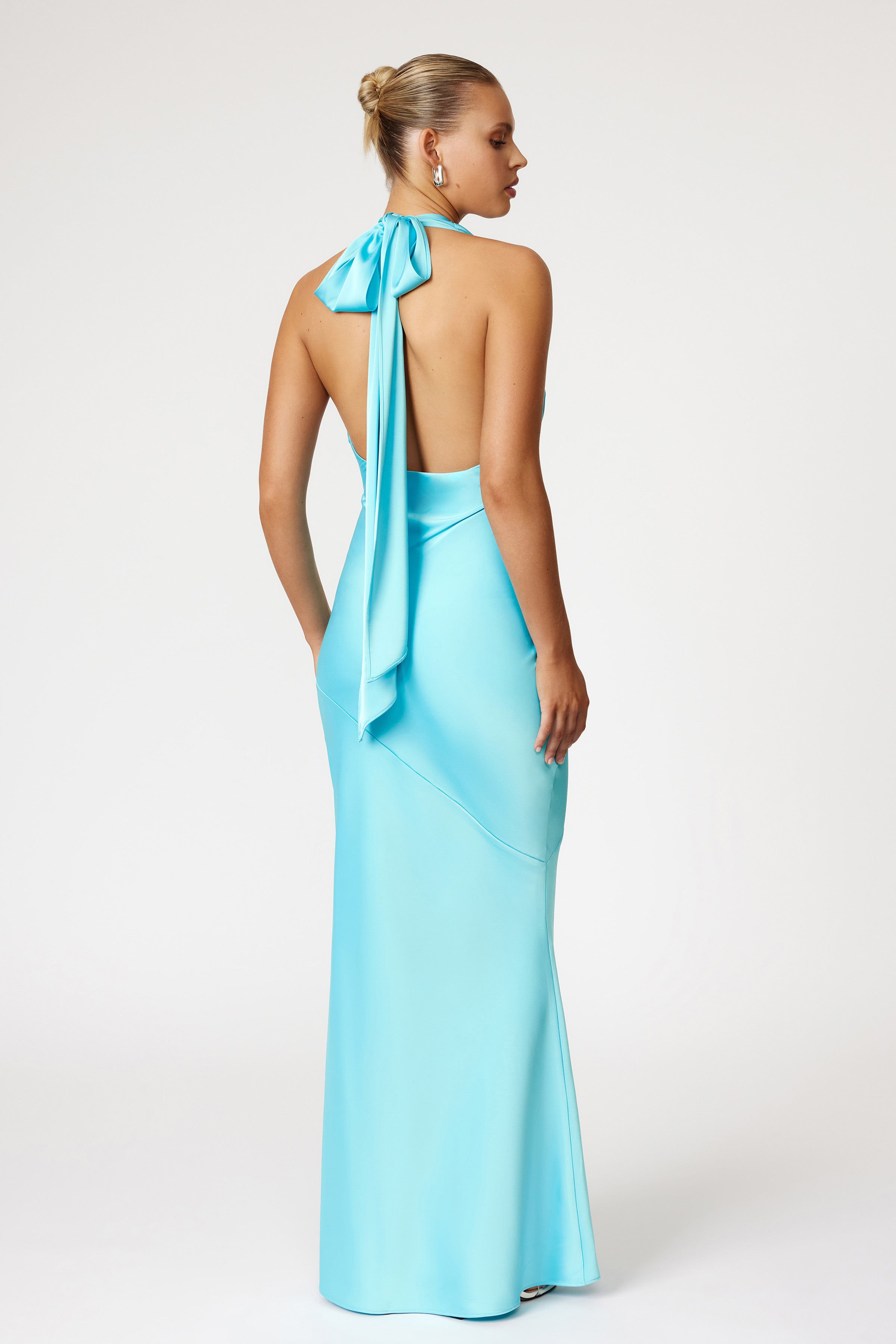 Amalia Dress featuring a backless halter neck with tie detail in lagoon blue for formal and bridesmaid occasions by Studio Lexi