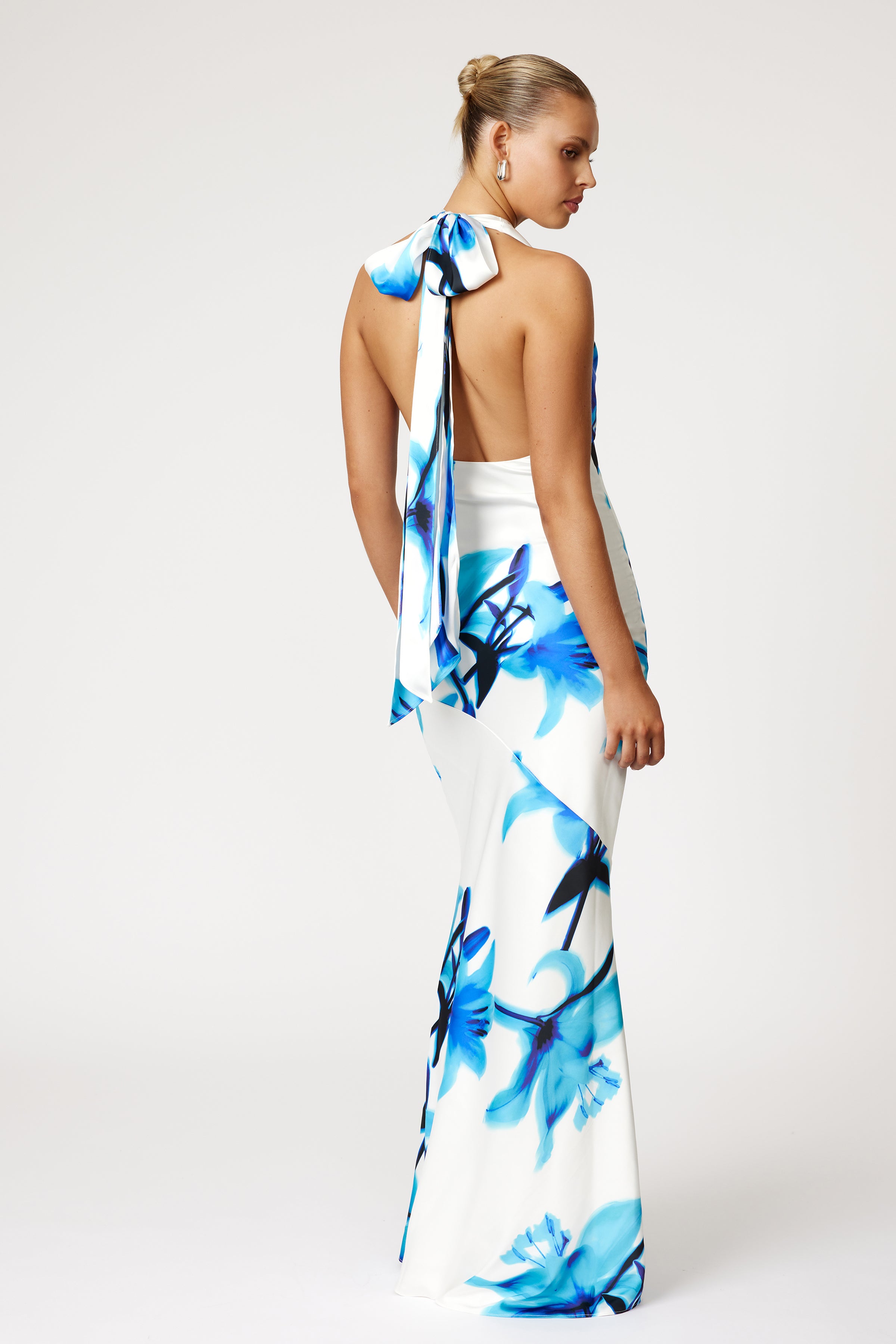 Amalia Dress Print with backless halter tie and bold blue floral pattern, elegant design by Studio Lexi