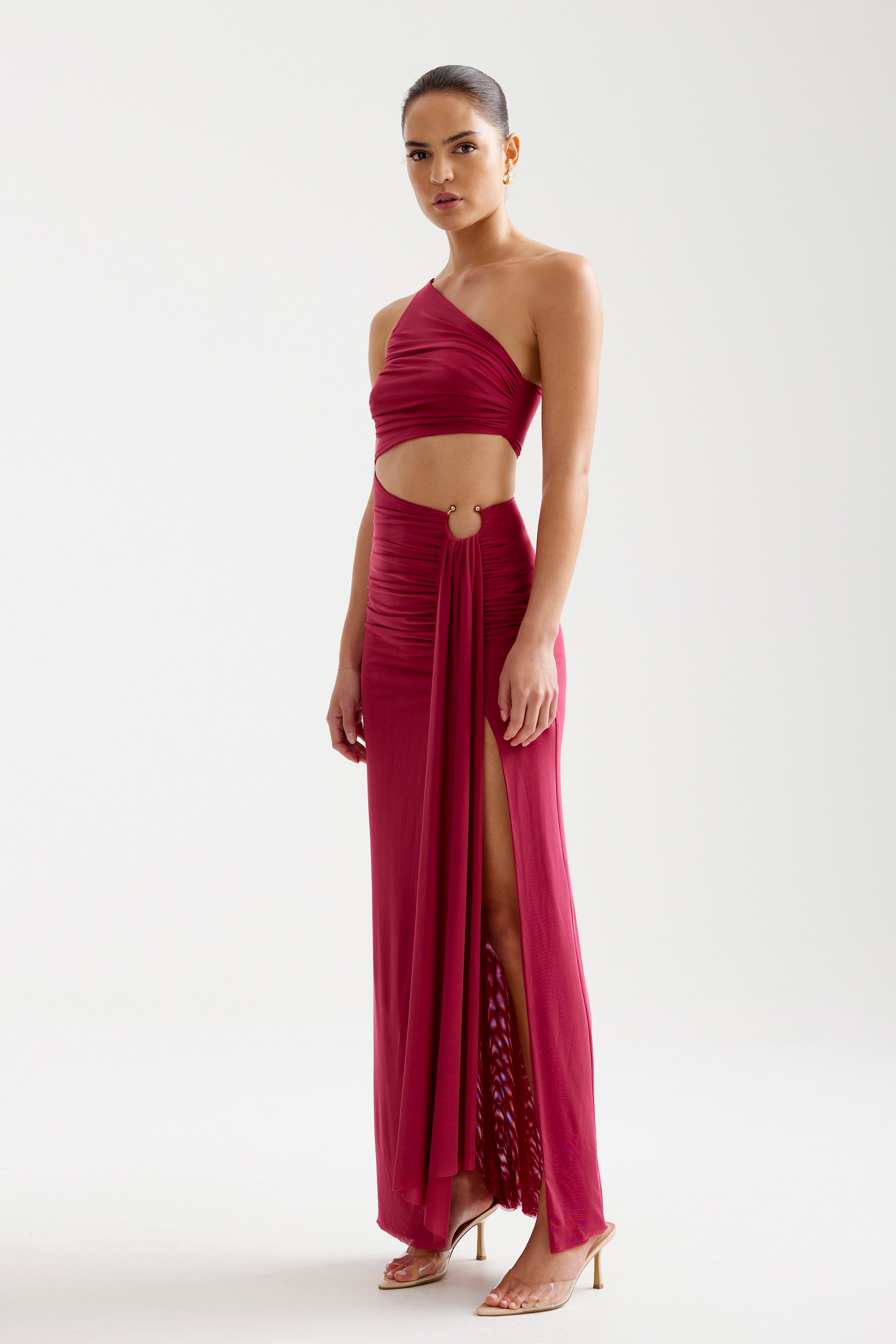 Asha Dress featuring a one-shoulder cutout design with high split and ring detail in wine by Studio Lexi