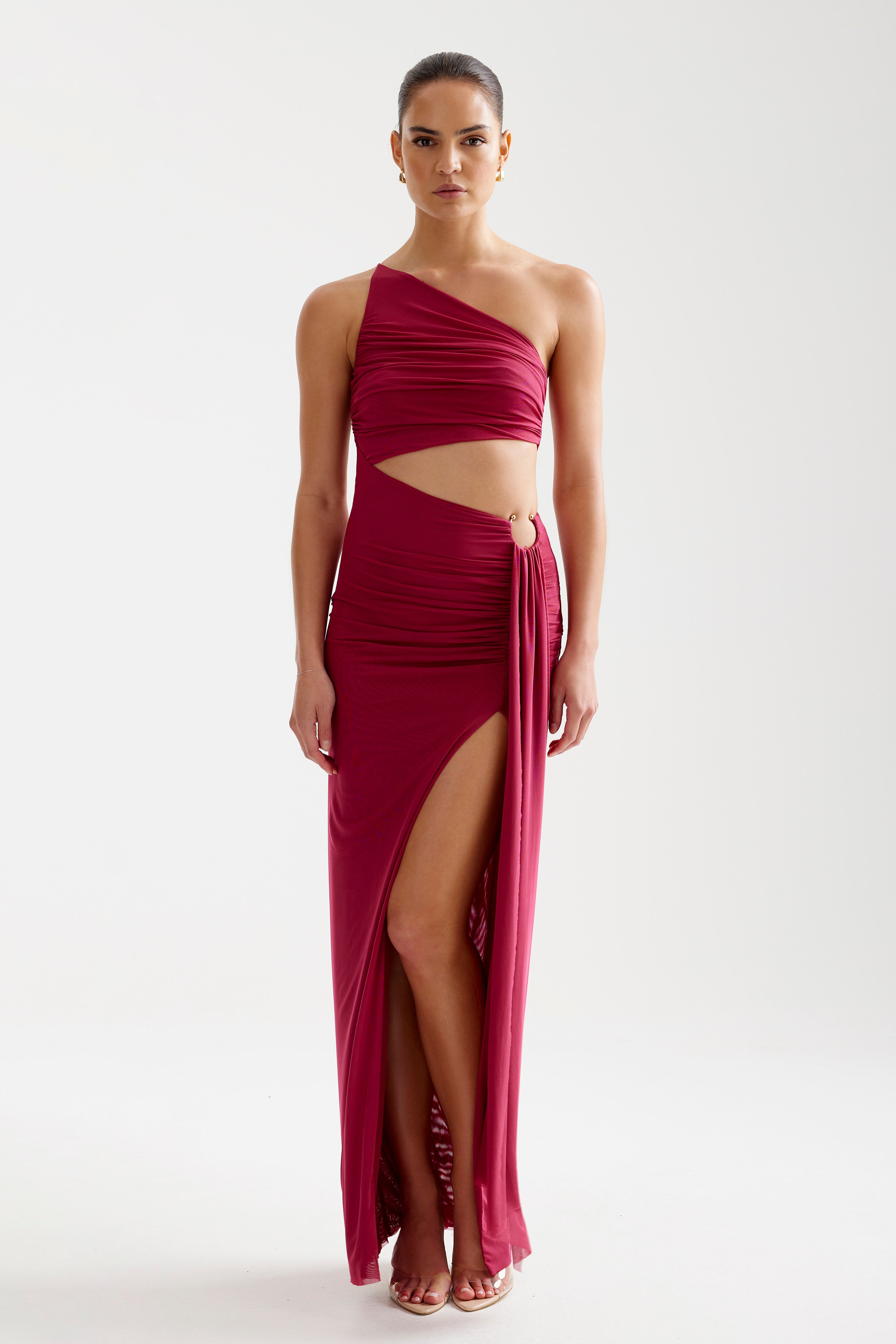 Asha Dress featuring an asymmetric cutout design with high split and ring detail in wine by Studio Lexi