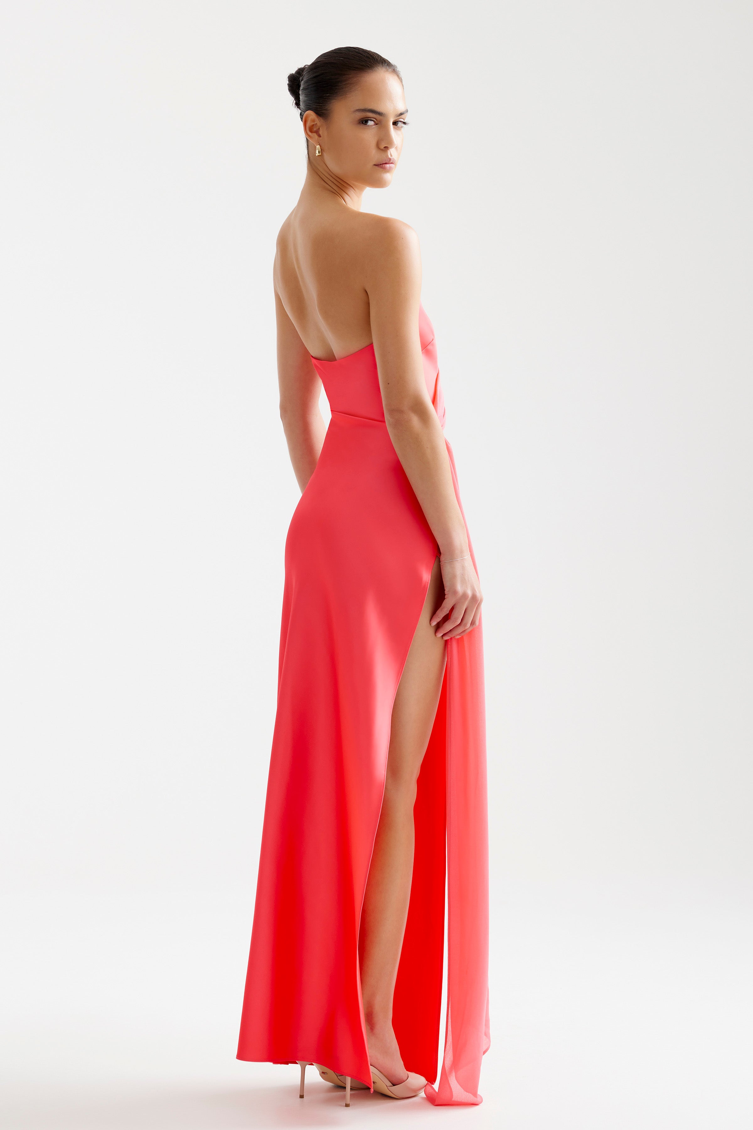 Aura Dress featuring a strapless silhouette with a thigh-high split in vibrant cranberry satin by Studio Lexi