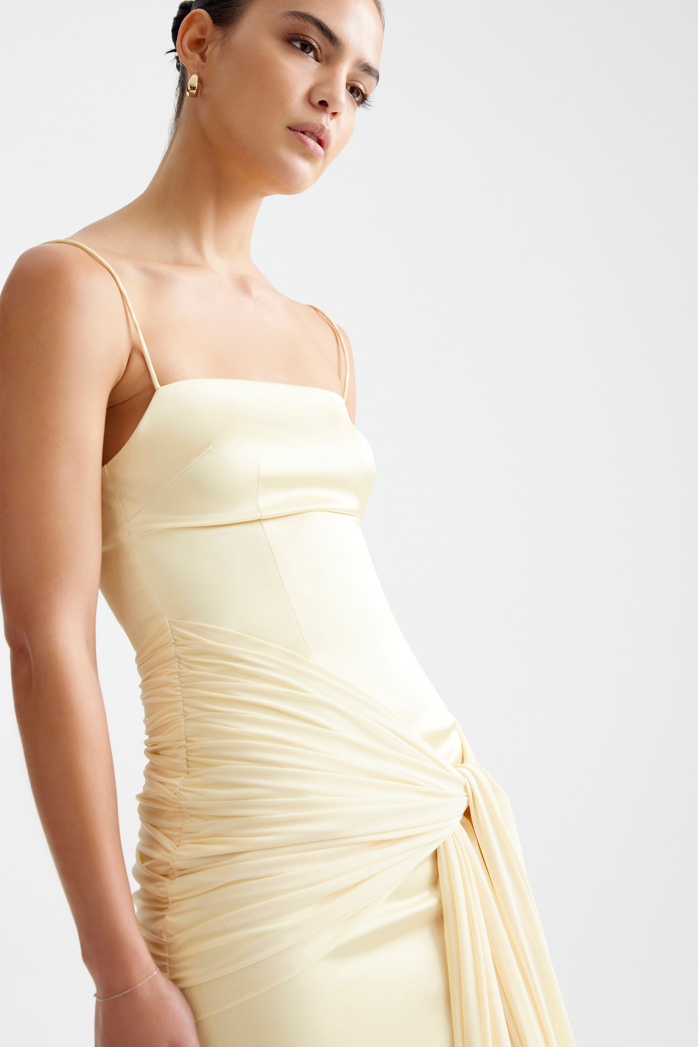 Ayla Dress featuring fitted silhouette with thin straps and draped ruched detailing in limoncello for formal occasions