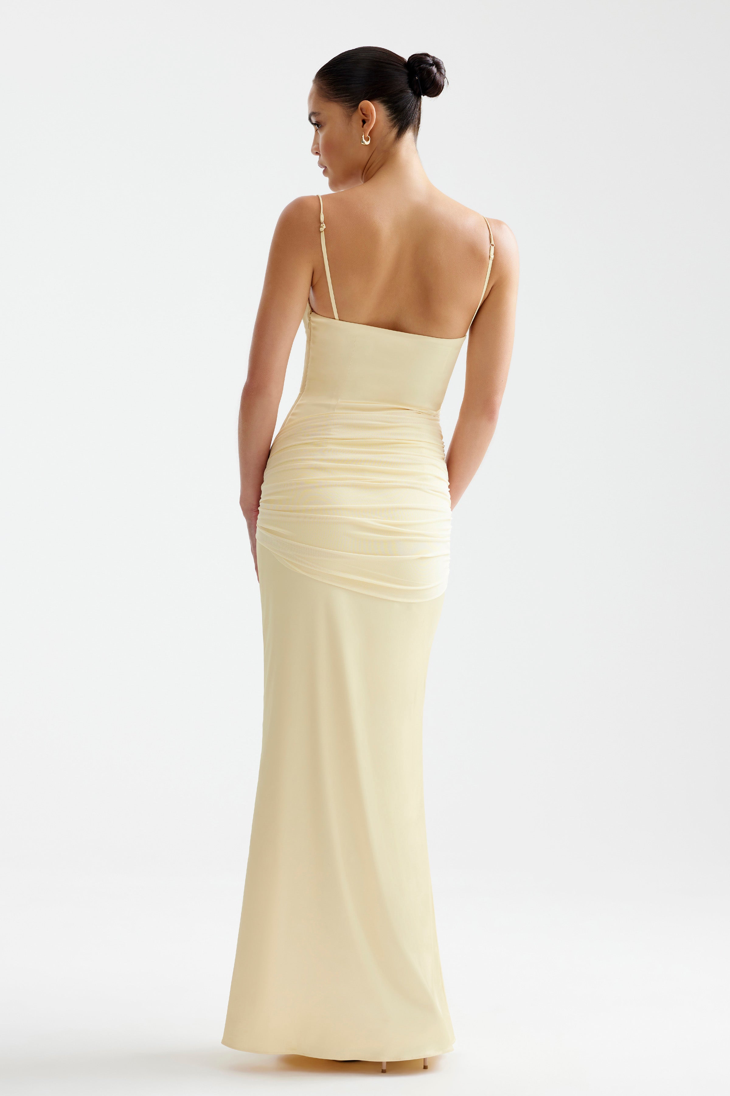 Ayla Dress featuring a slim ruched silhouette with adjustable straps in soft limoncello for formal and evening occasions