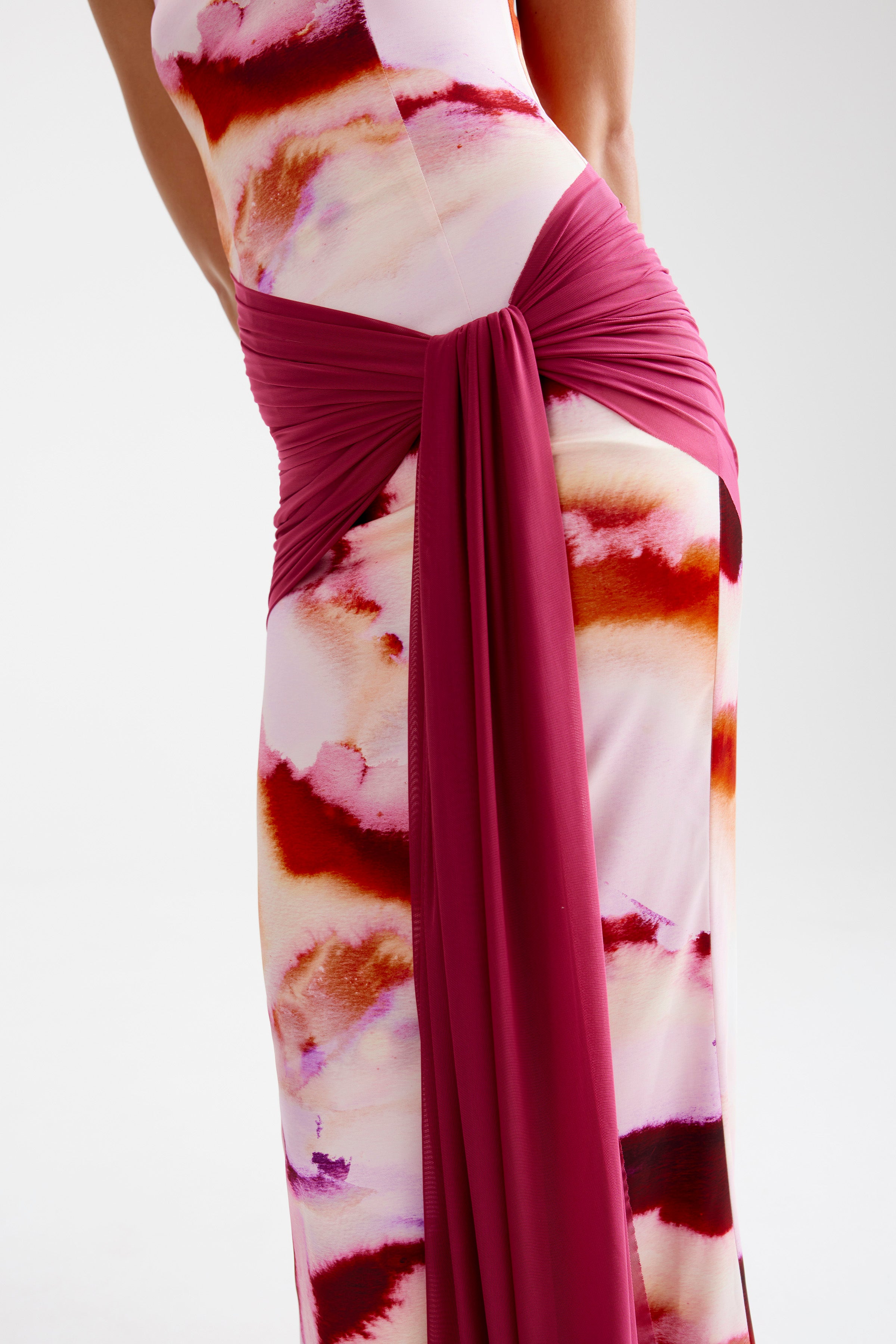 Ayla Dress featuring a sleek silhouette with draped sash detail in vibrant pink mineral print for formal occasions