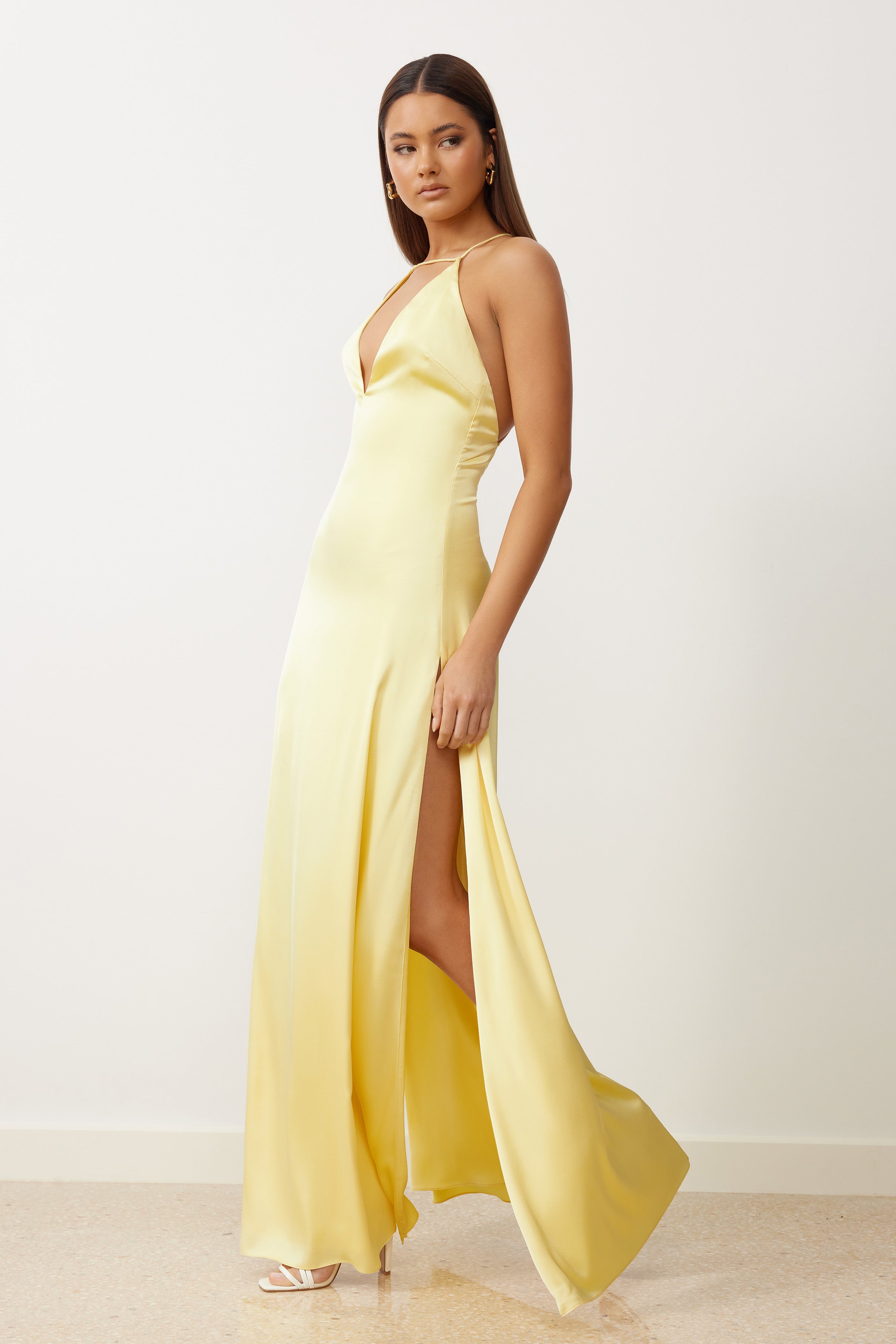 Bali Dress featuring a backless silhouette and thigh-high split in lemon satin for formal and bridesmaid occasions