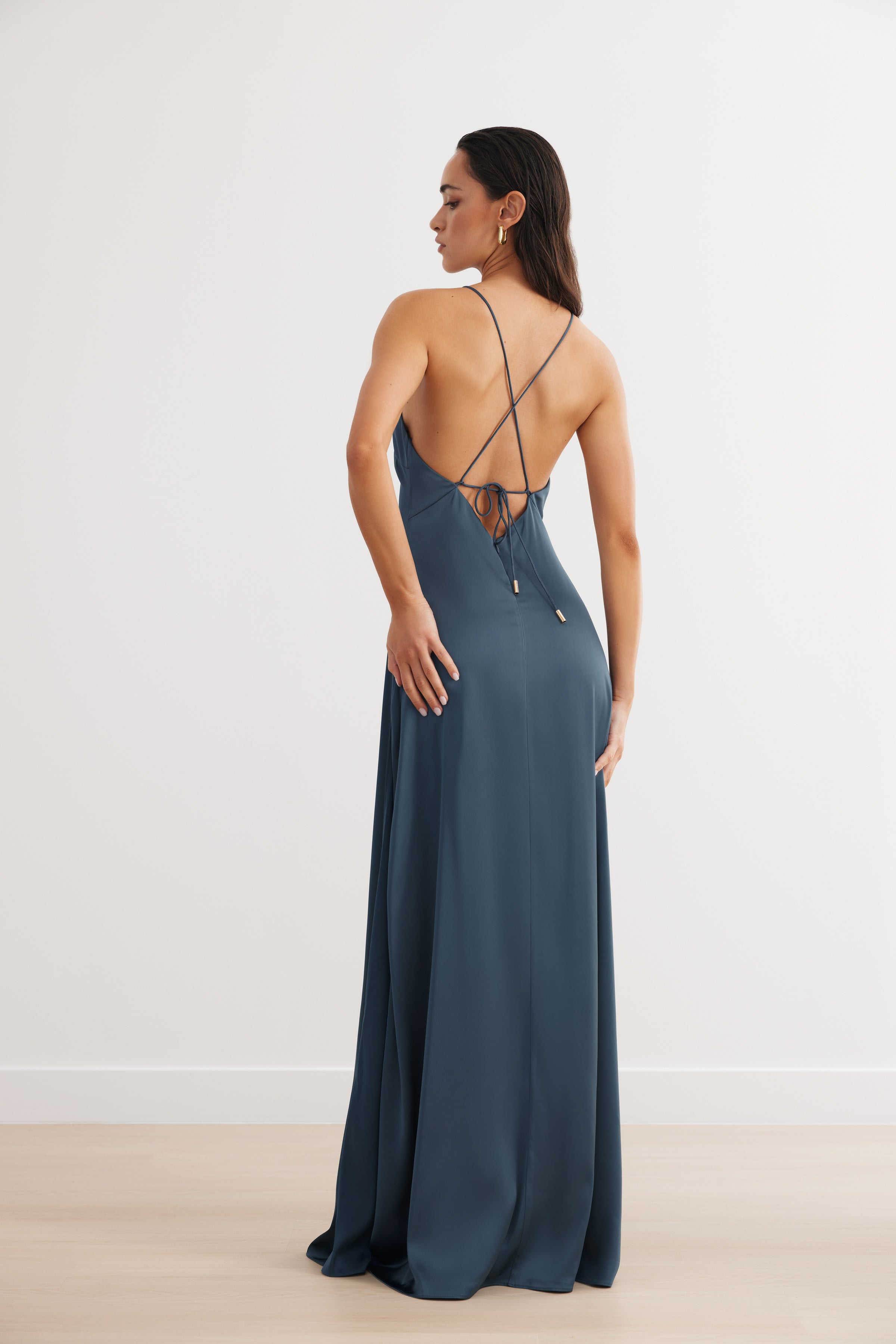 Bali Dress featuring a backless design with crisscross straps in steel blue satin for formal and black tie occasions