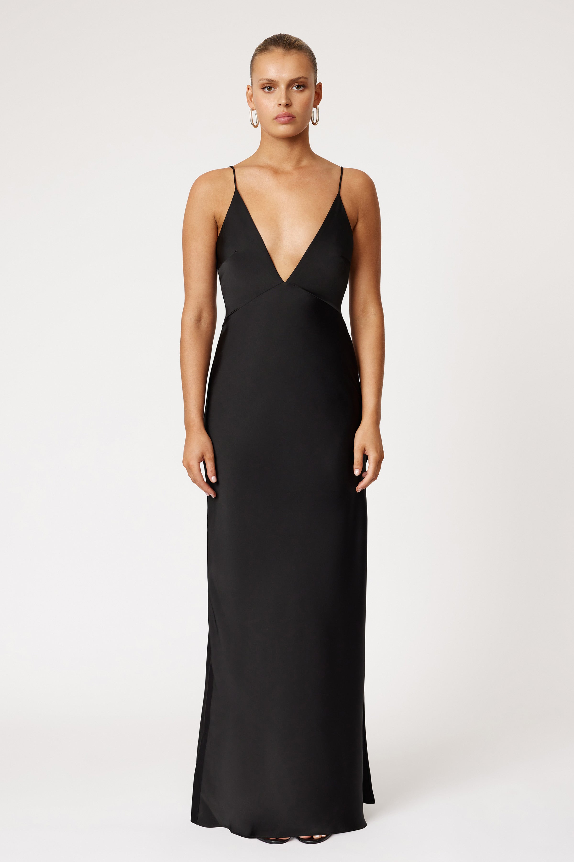 Bondi Dress featuring a sleek silhouette with deep V-neckline, thin straps, and elegant black fabric for formal occasions