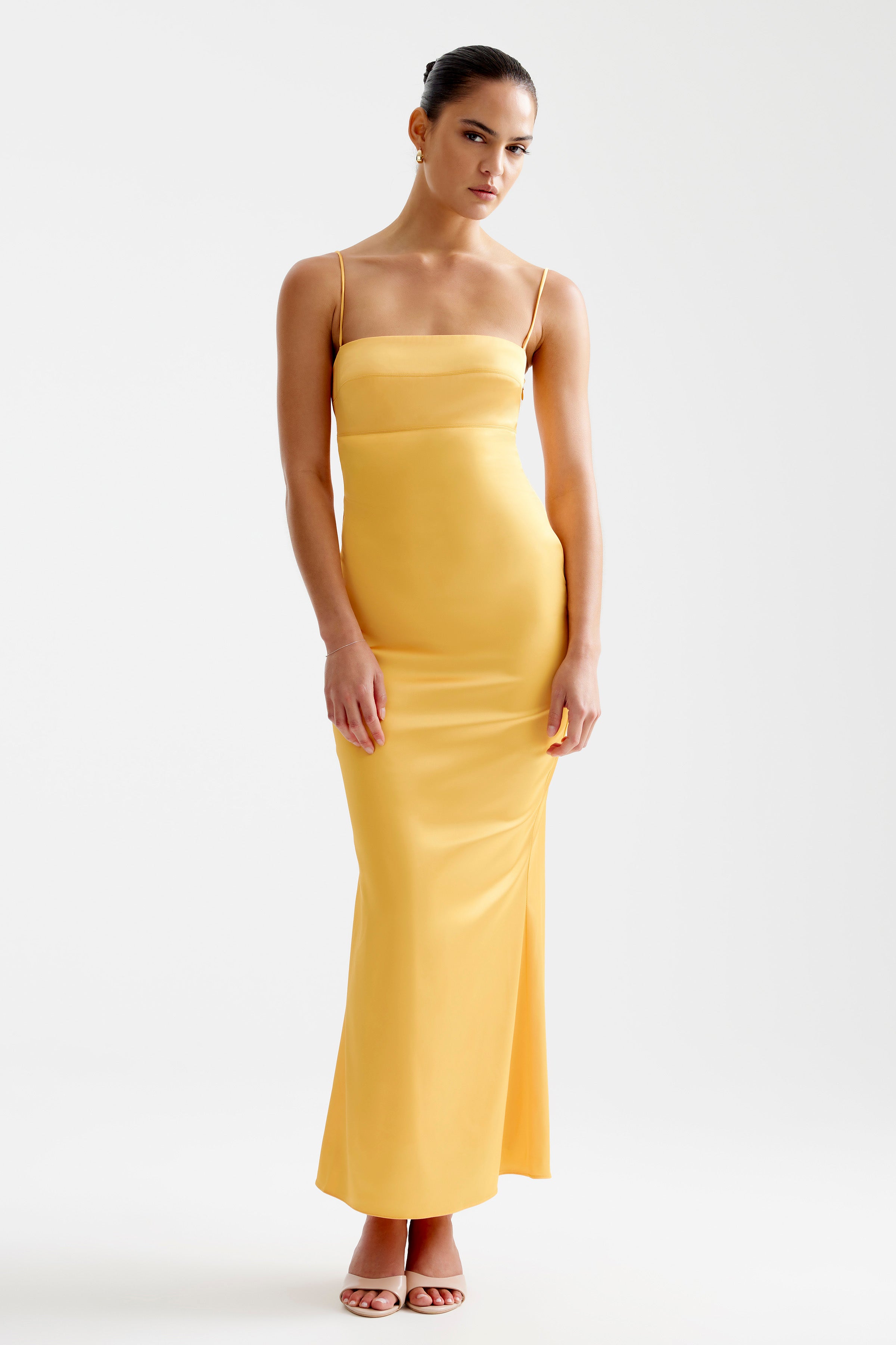 Bora Dress featuring a sleek fitted design with thin straps in papaya perfect for bridesmaid and formal occasions by Studio Lexi