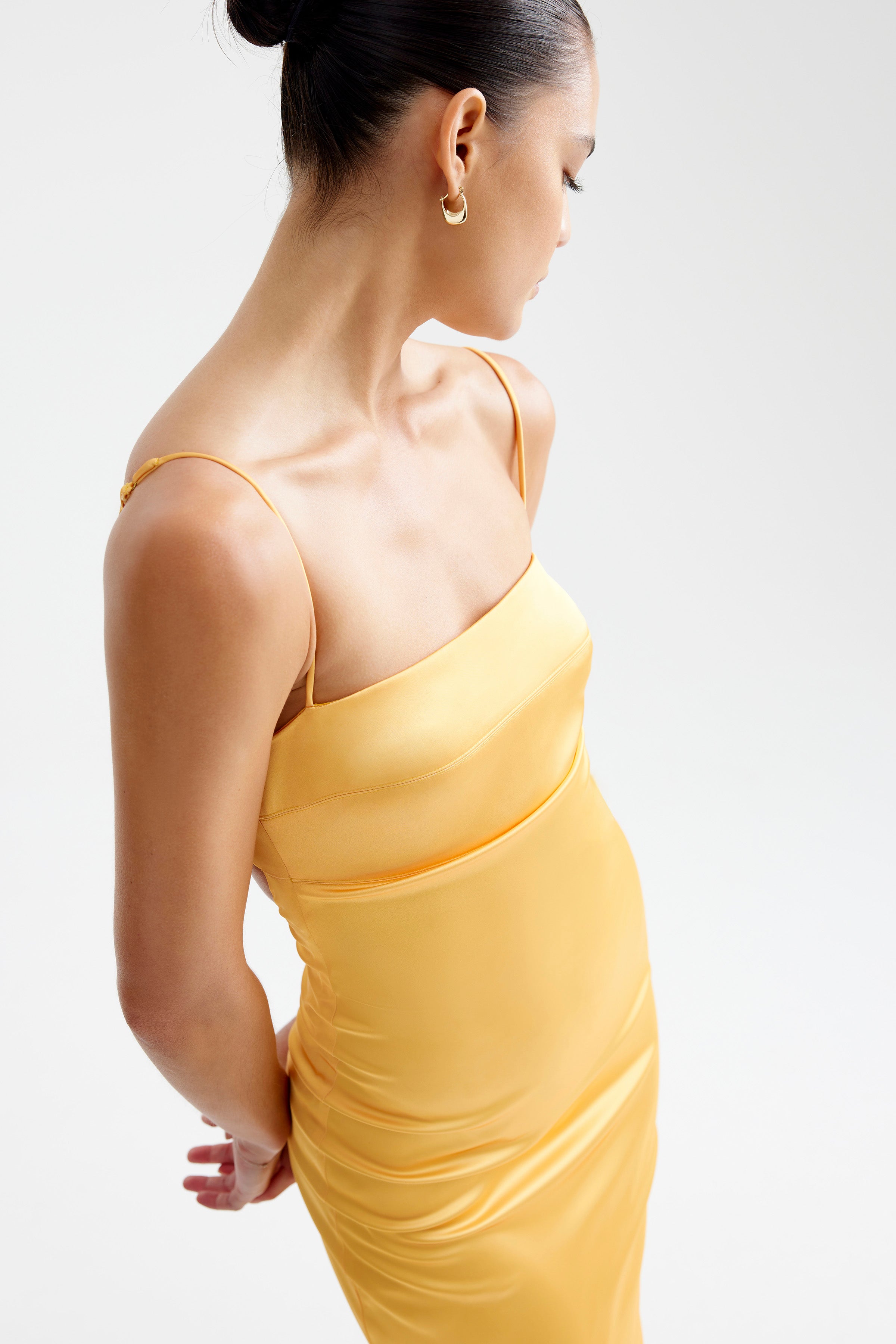 Bora Dress featuring a sleek fitted design with thin adjustable straps in papaya for formal and cocktail events by Studio Lexi