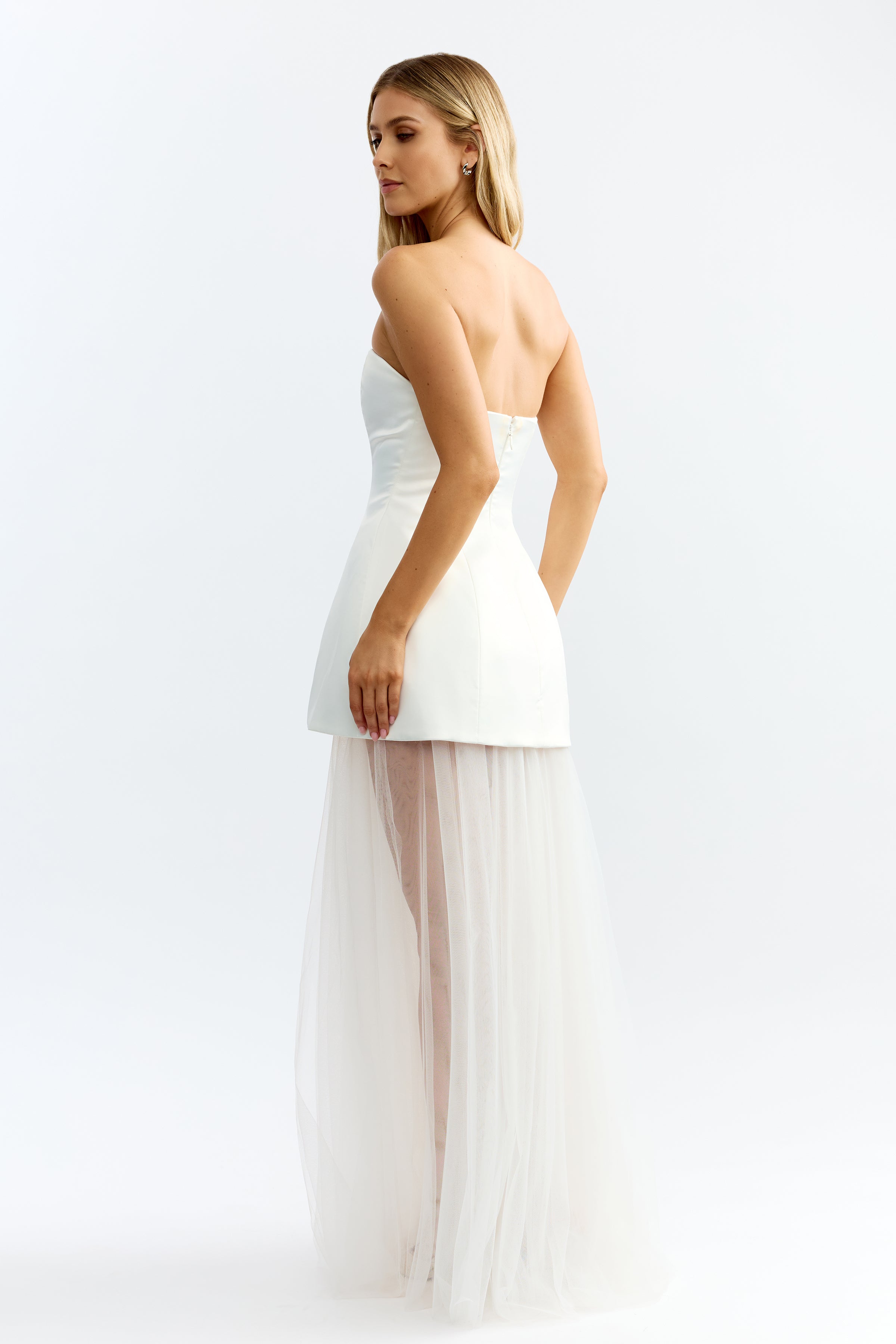 Brigitte Dress featuring a strapless fitted bodice with a sheer flowing skirt in ivory for formal occasions