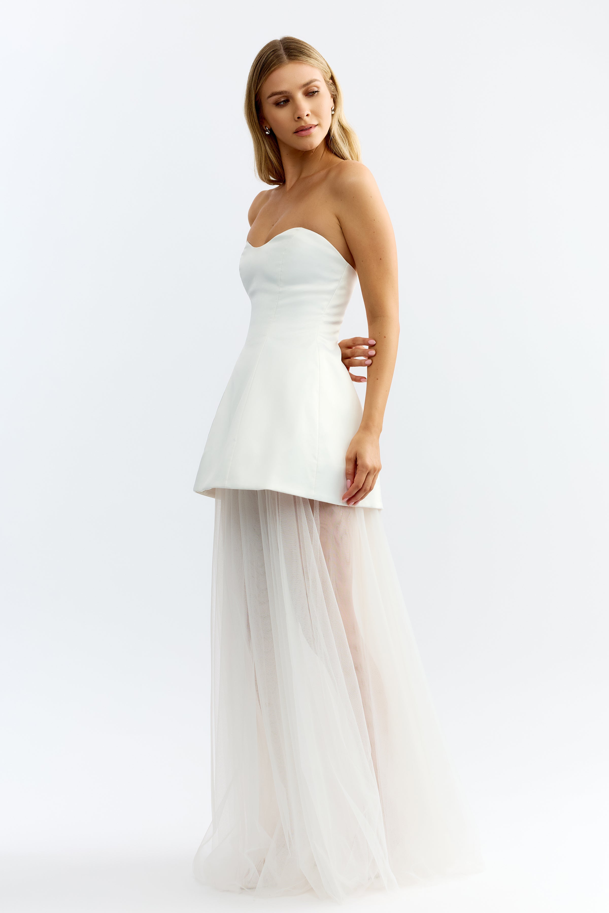 Brigitte Dress featuring a strapless fitted bodice and sheer flowing skirt in ivory for formal and wedding guest occasions