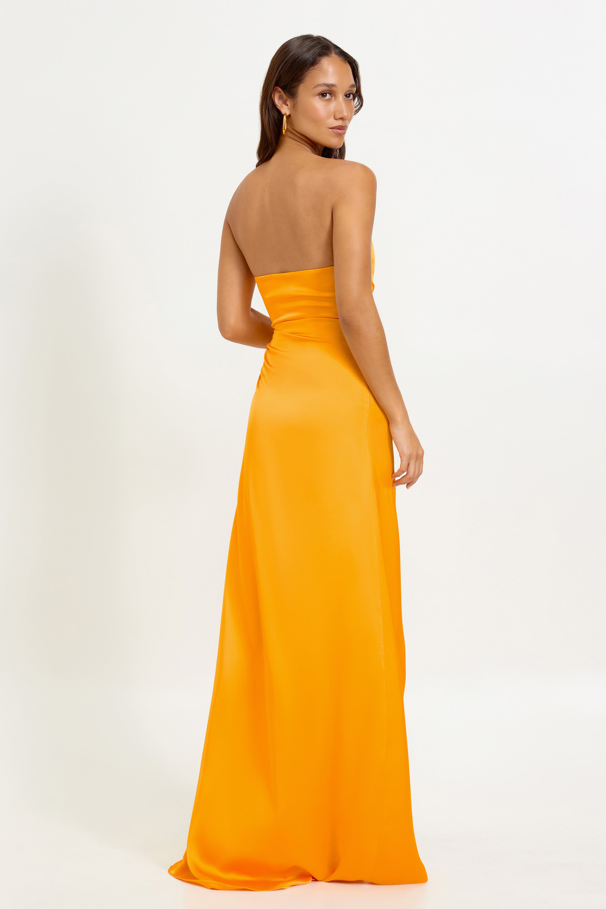Camilo Dress featuring a strapless backless silhouette in vibrant mango for formal and wedding guest occasions