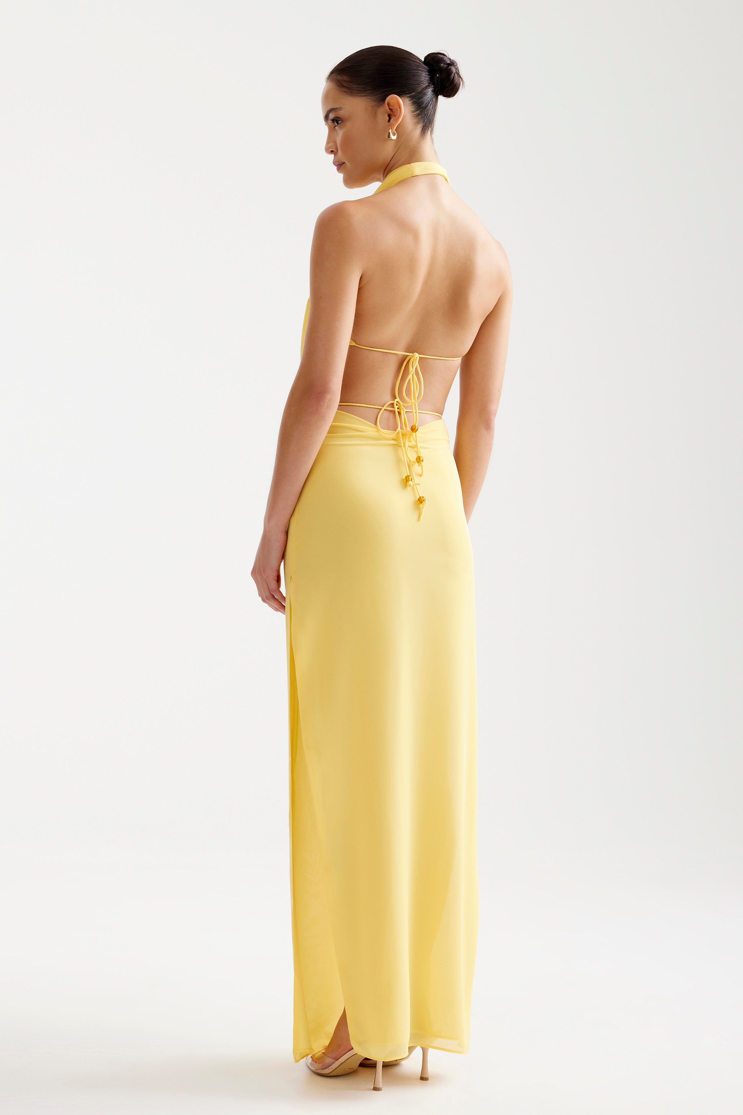 Clio Set featuring a backless design with adjustable ties in vibrant yellow for elegant cocktail and party occasions