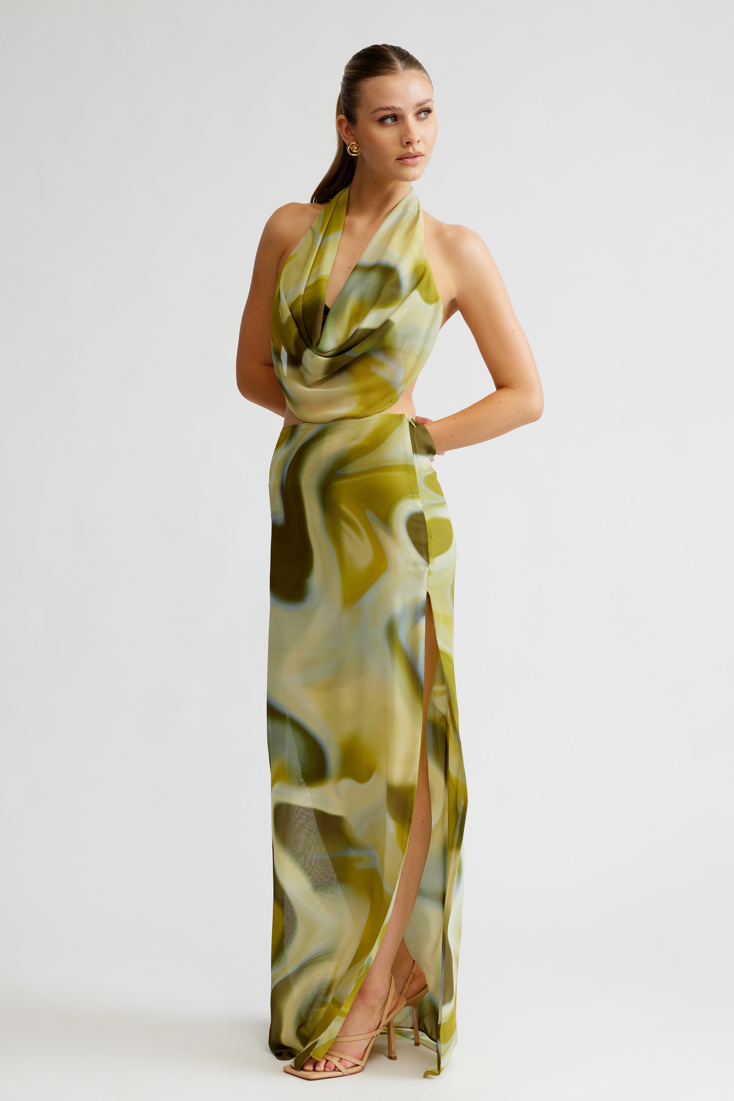 Clio Set featuring a backless geo print top with draped neckline and high split skirt in green tones for formal occasions