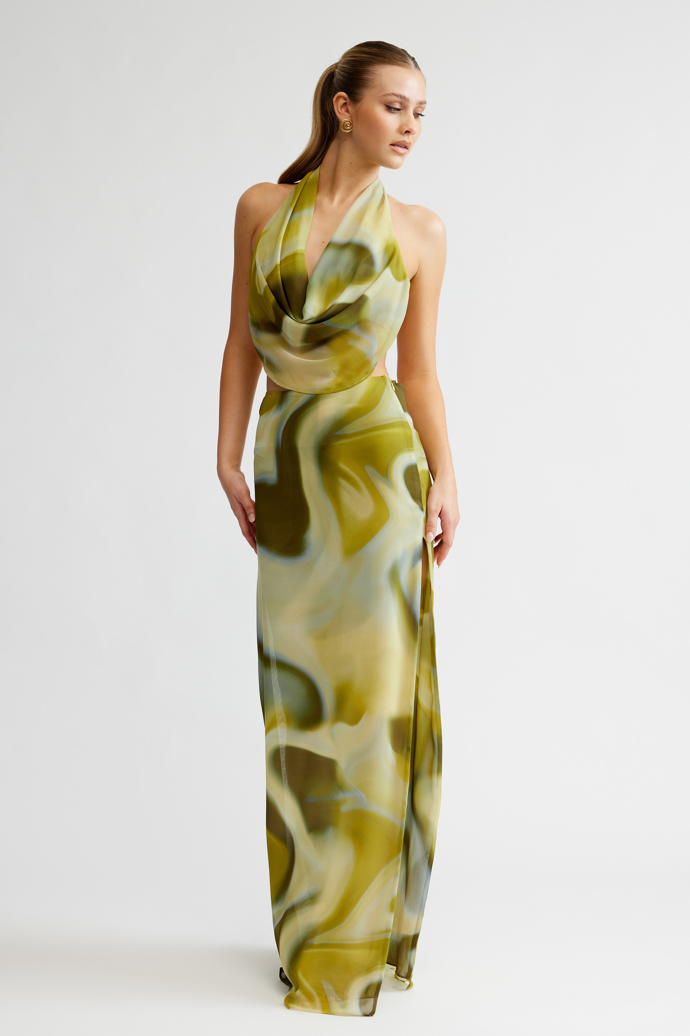 Clio Set featuring a flowing backless top with draped neckline and a long printed skirt with side split in green tones