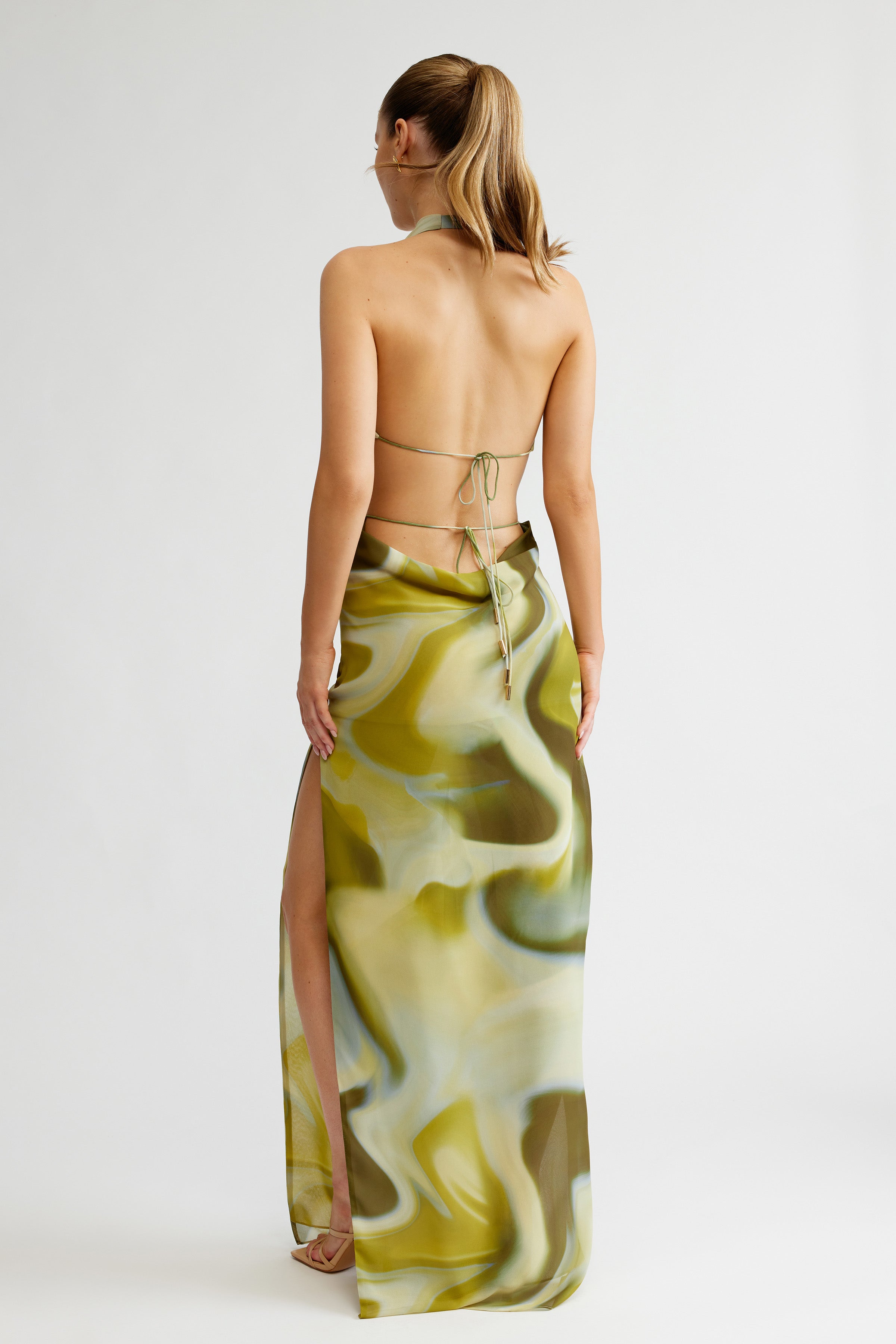 Clio Set featuring a backless halter top with tie detail and a flowing printed skirt with side split for formal occasions