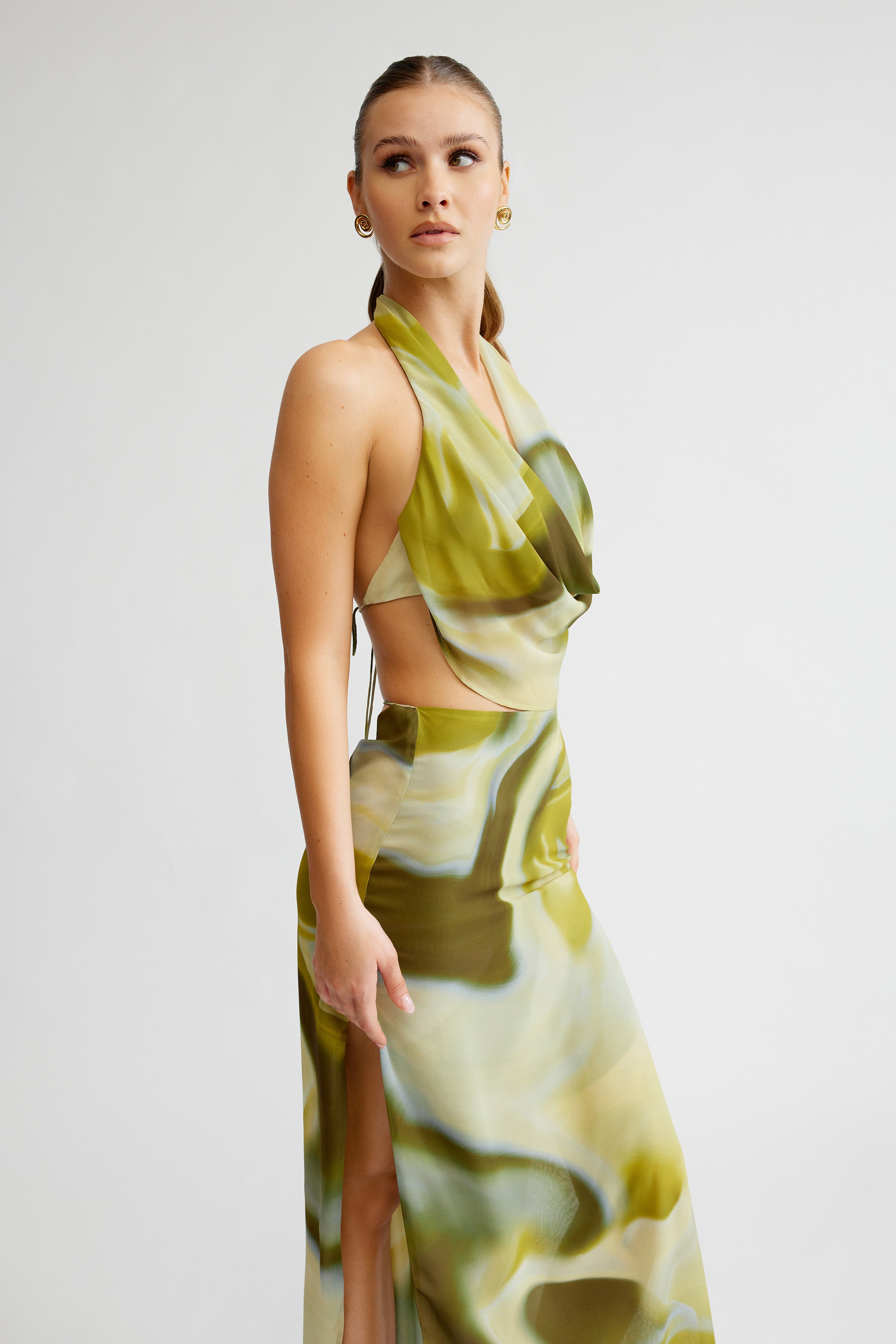 Clio Set featuring a backless halter top and high split skirt in green and cream tones for formal occasions