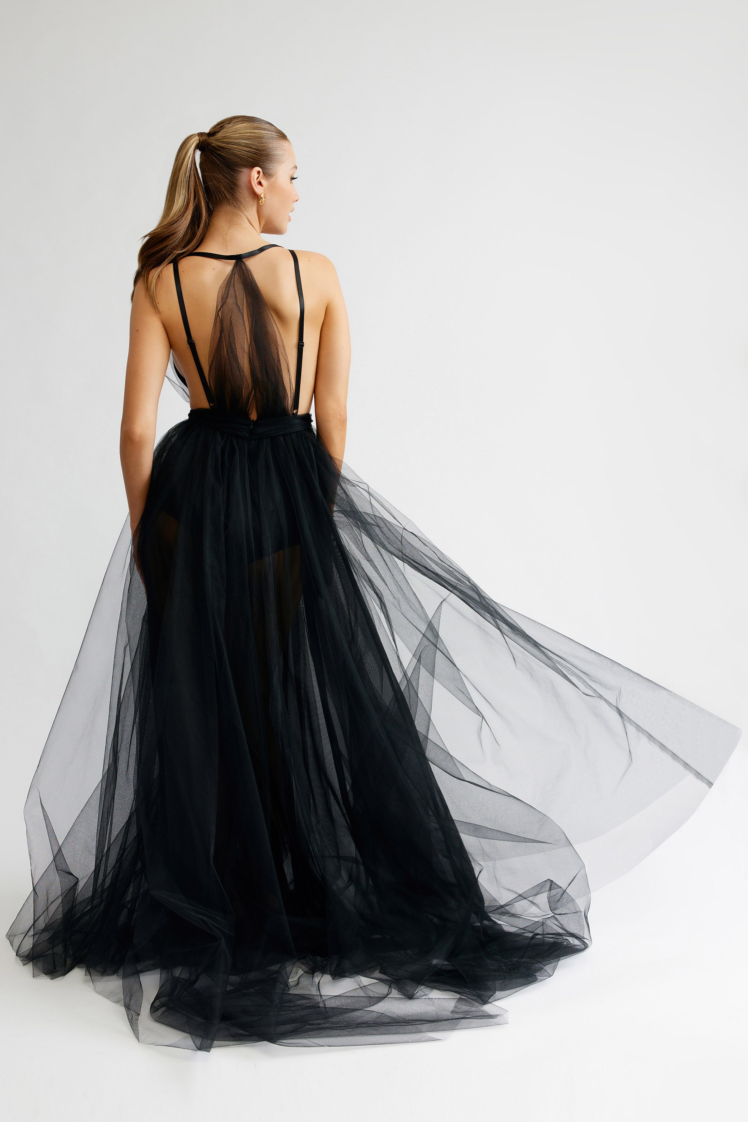 Cynthia Dress featuring a sheer back with multiple straps and flowing black tulle skirt with small train for formal occasions