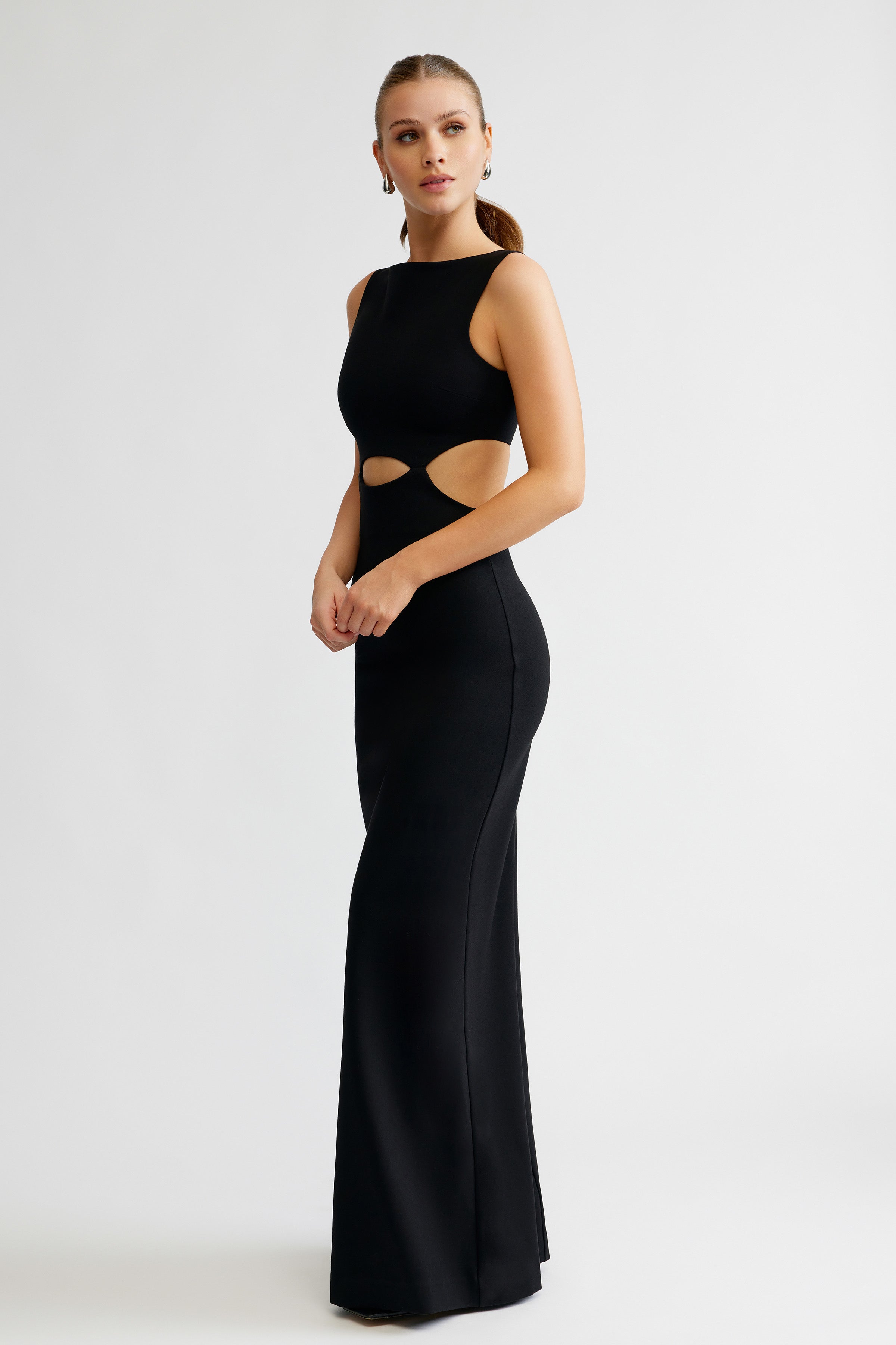 Elise Dress sleek fitted design with side cutouts and sleeveless silhouette in black for formal evening occasions