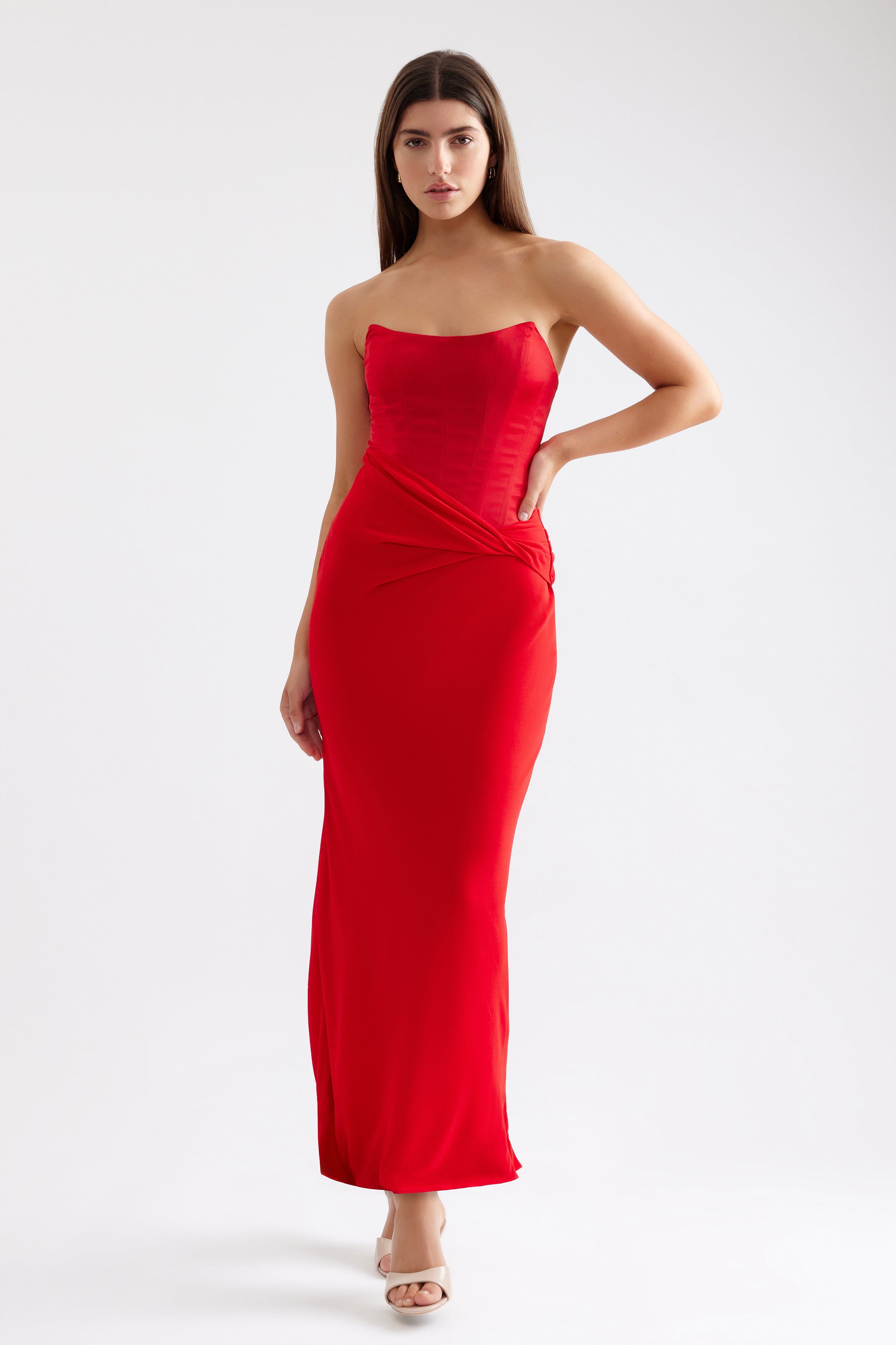 Elora Dress features a strapless silhouette with ruched detailing in vibrant scarlet for formal and black tie events