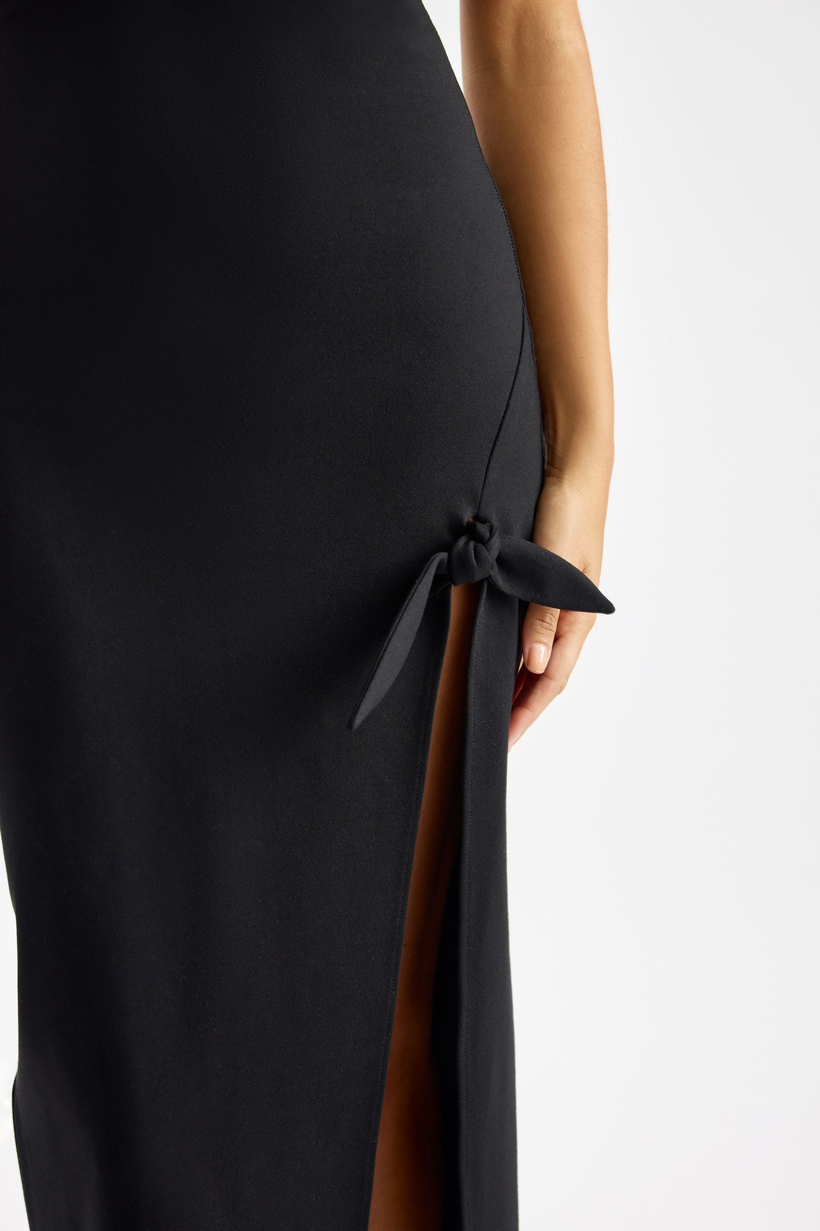 Evana Dress sleek fitted design with side slit and knot detail in black for cocktail and evening by Studio Lexi