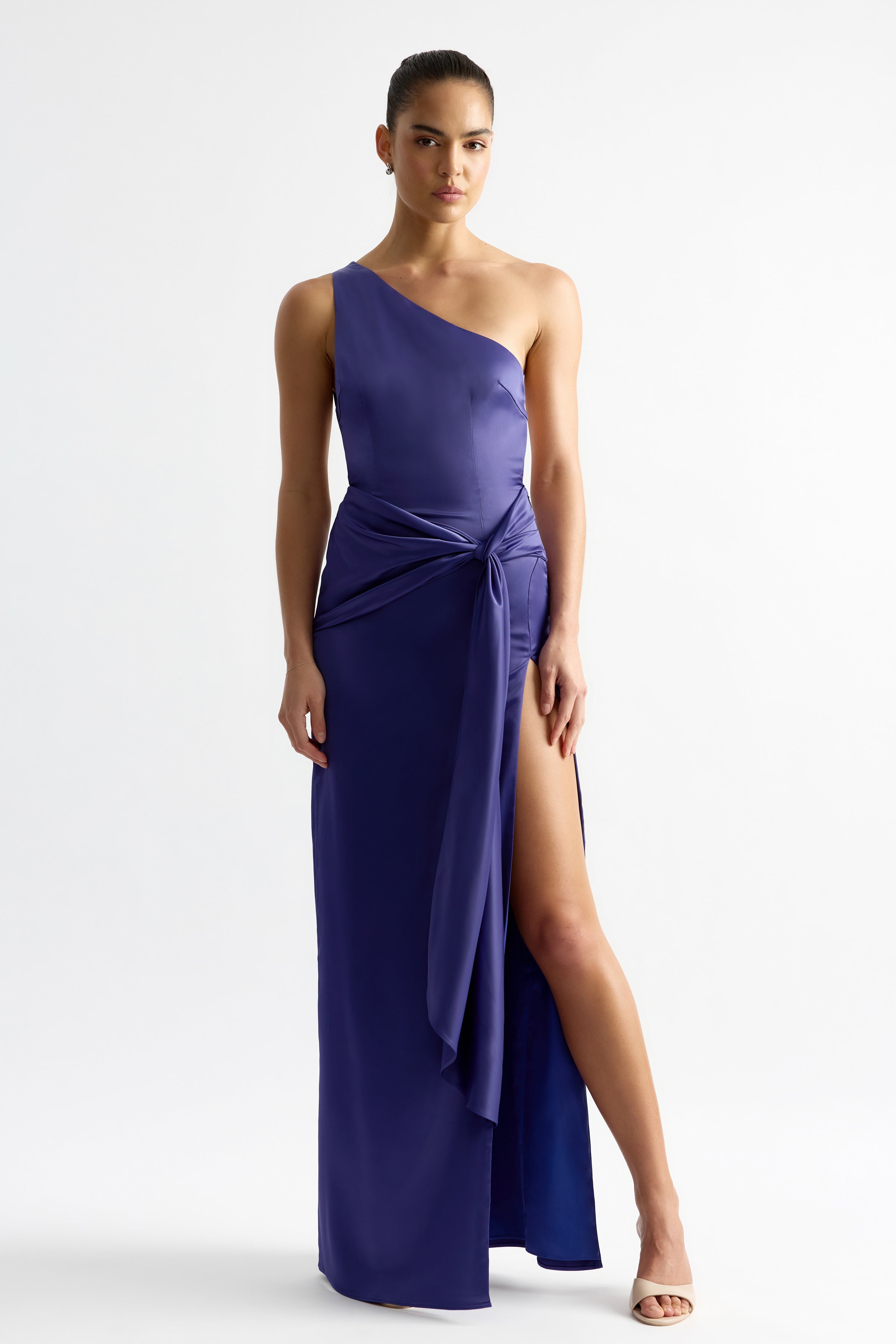 Fabienne Dress featuring an elegant asymmetrical shoulder and high slit with draped detail in indigo satin by Studio Lexi