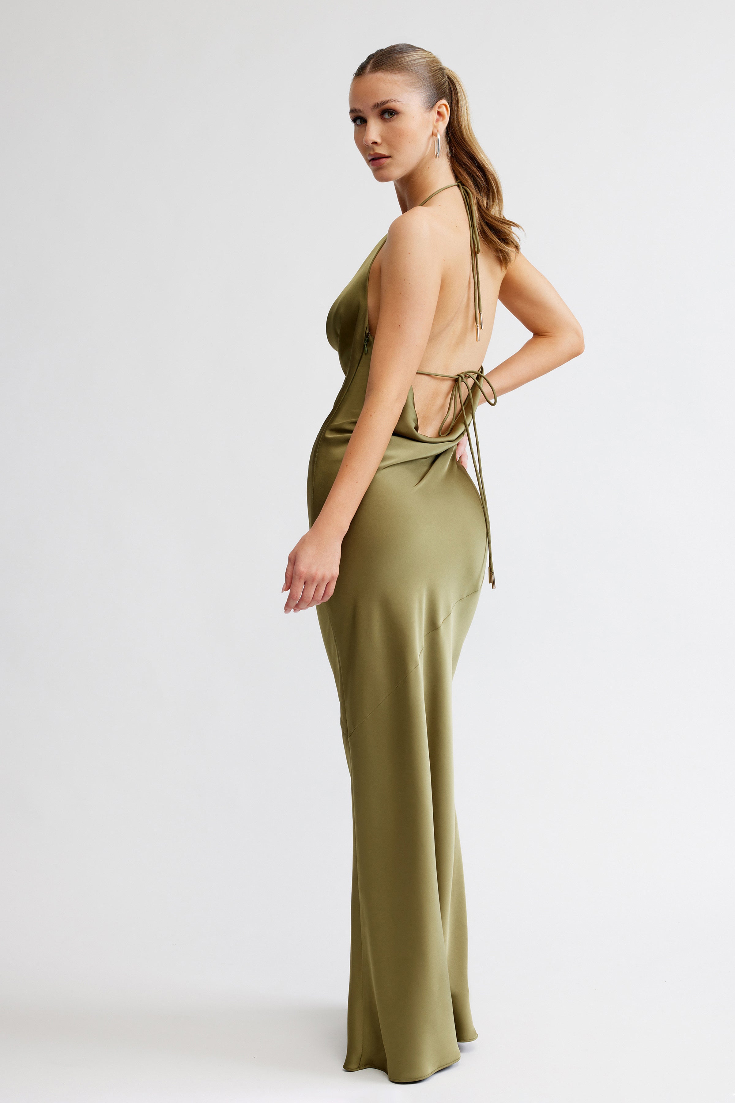 Freya Dress featuring a backless, tie-back design and elegant draped silhouette in olive satin for formal occasions