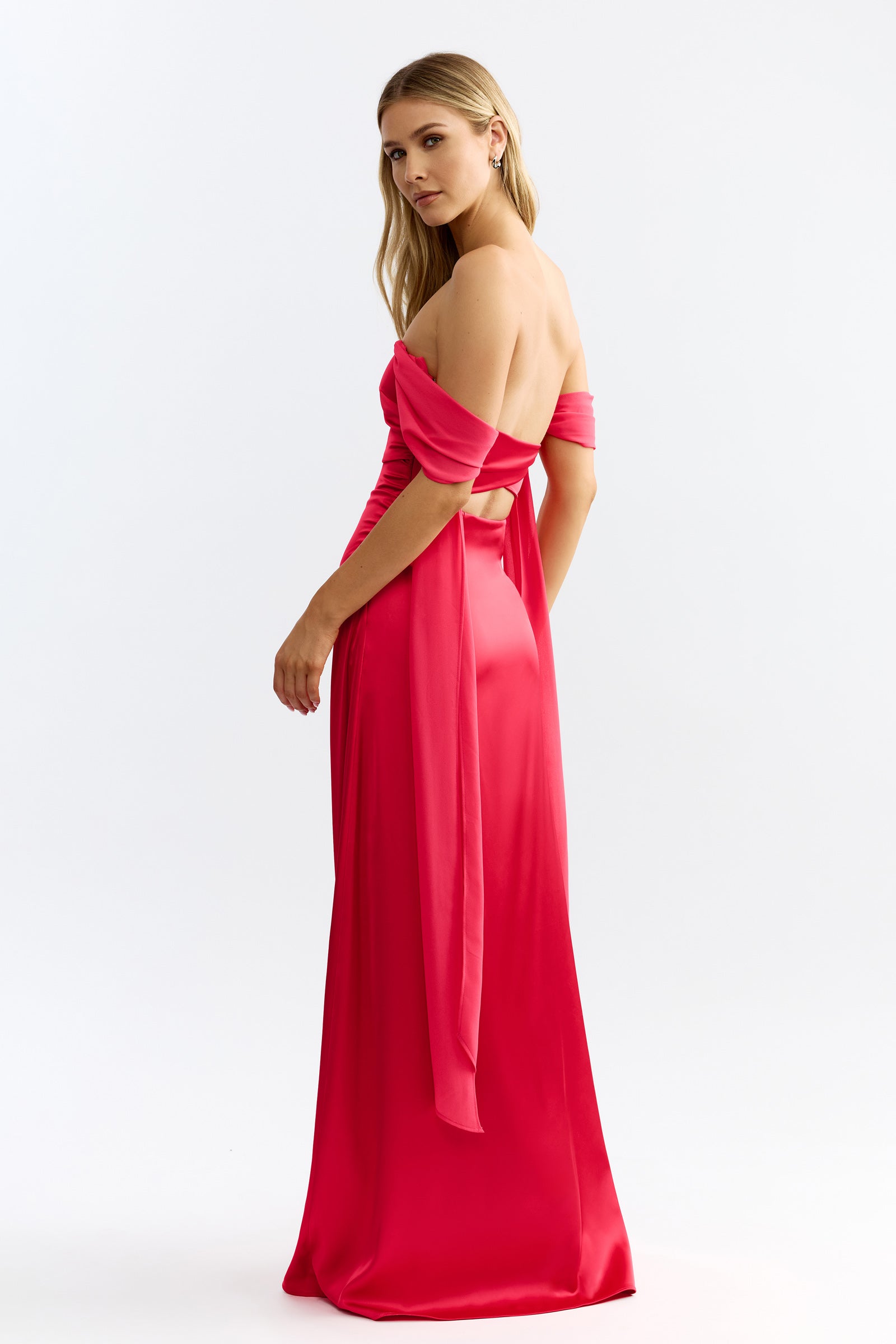 Hattie Dress featuring an off-shoulder, open back silhouette with flowing sash detail in raspberry by Studio Lexi