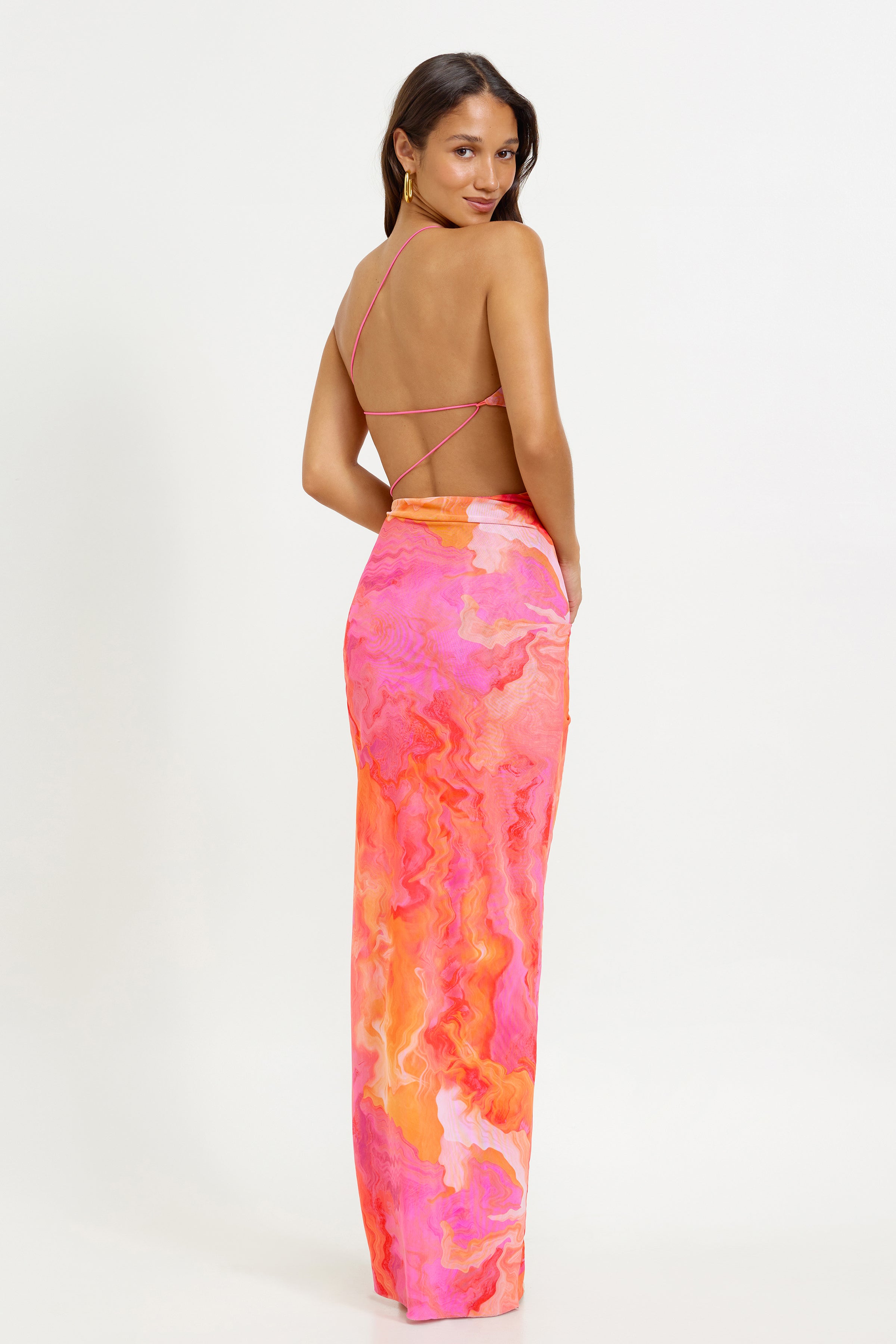 Havana Dress featuring a printed vibrant pink and orange fabric with a backless design and slim straps for party and cocktail events