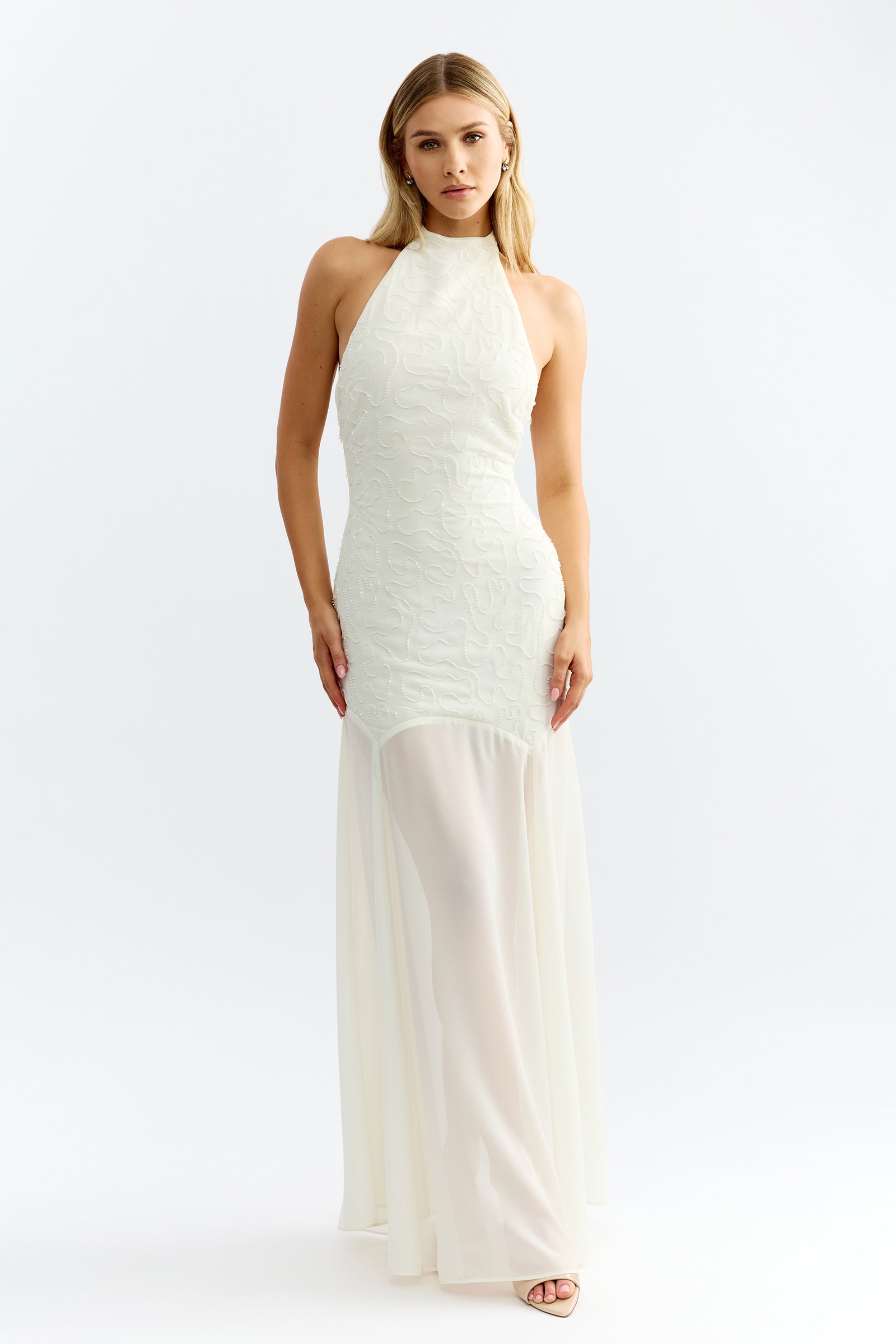 Imani Dress featuring halter neck, detailed textured bodice, and sheer flowing skirt in ivory for formal and bridesmaid occasions by Studio Lexi