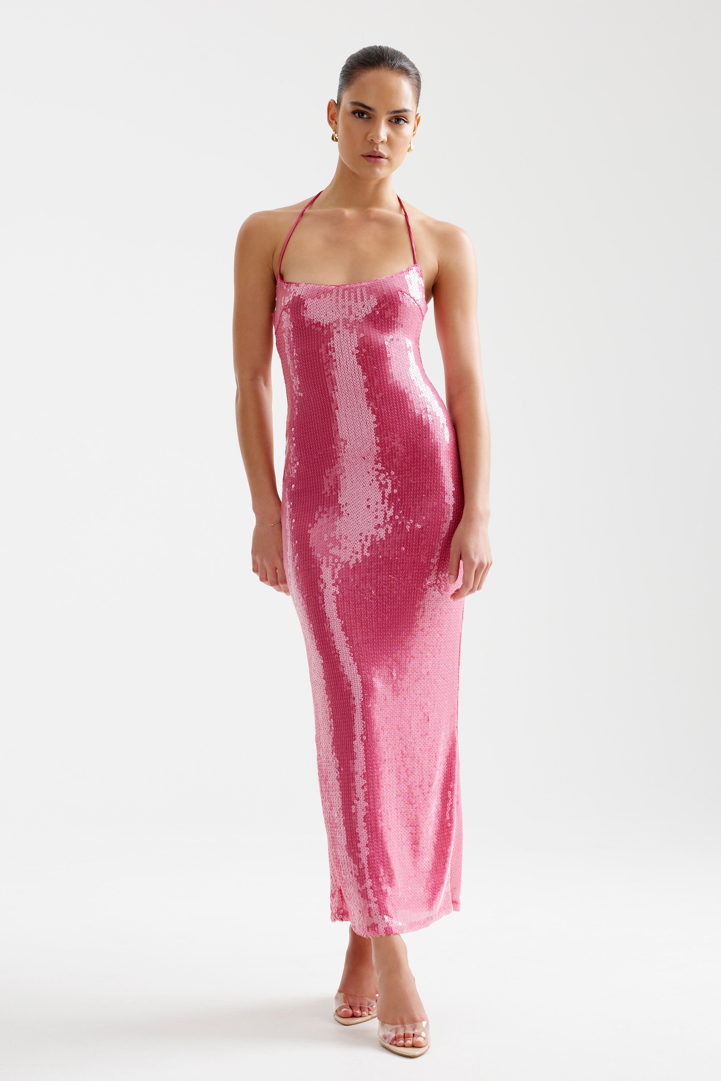 Imma Dress features a sleek fitted silhouette with a halter neckline and shimmering sequins in bright melon for evening occasions