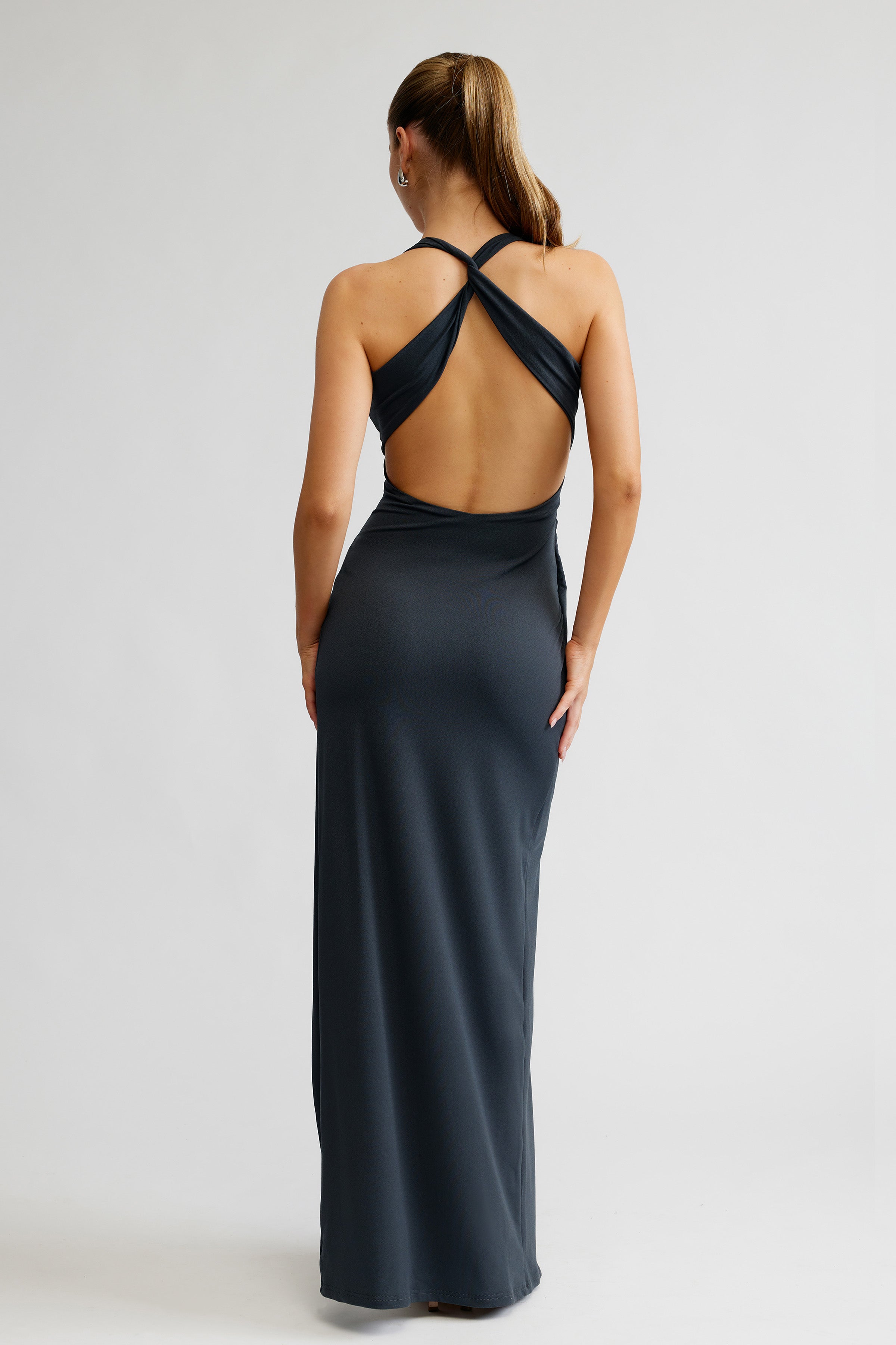 Iva Dress featuring a backless design with crisscross straps and a sleek fit in charcoal for formal events