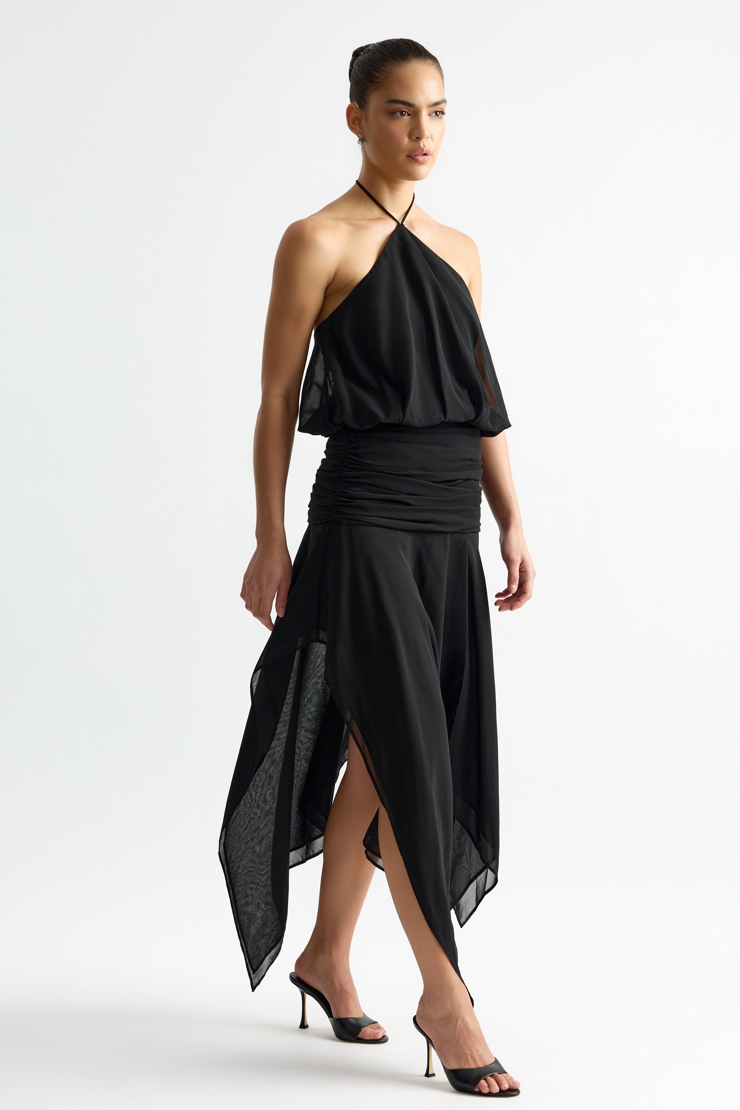 Jean Dress featuring a halter neck and flowing asymmetrical skirt in black for elegant formal occasion wear by Studio Lexi