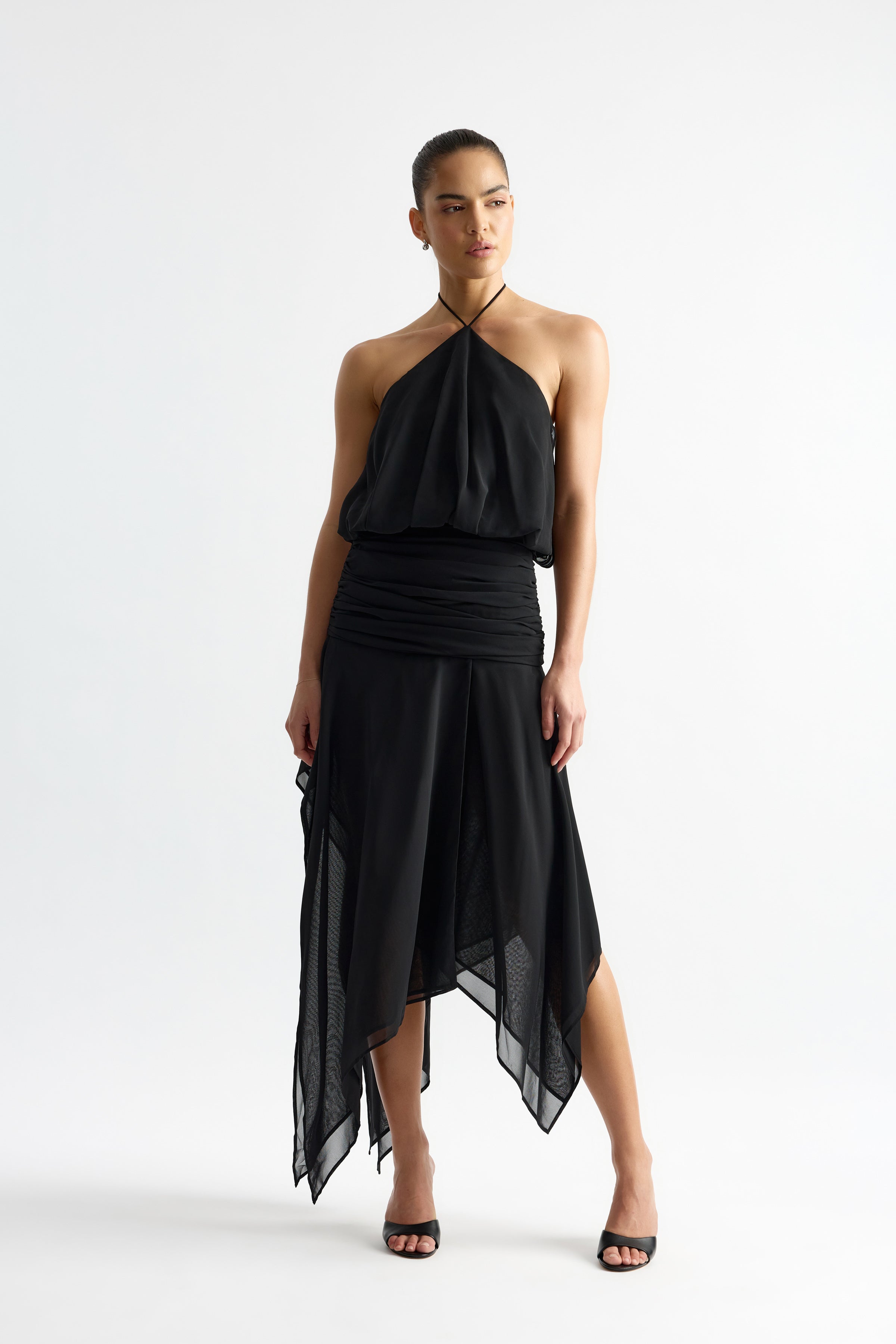 Jean Dress featuring a halter neckline and asymmetrical hem in black for elegant evening and occasion wear by Studio Lexi