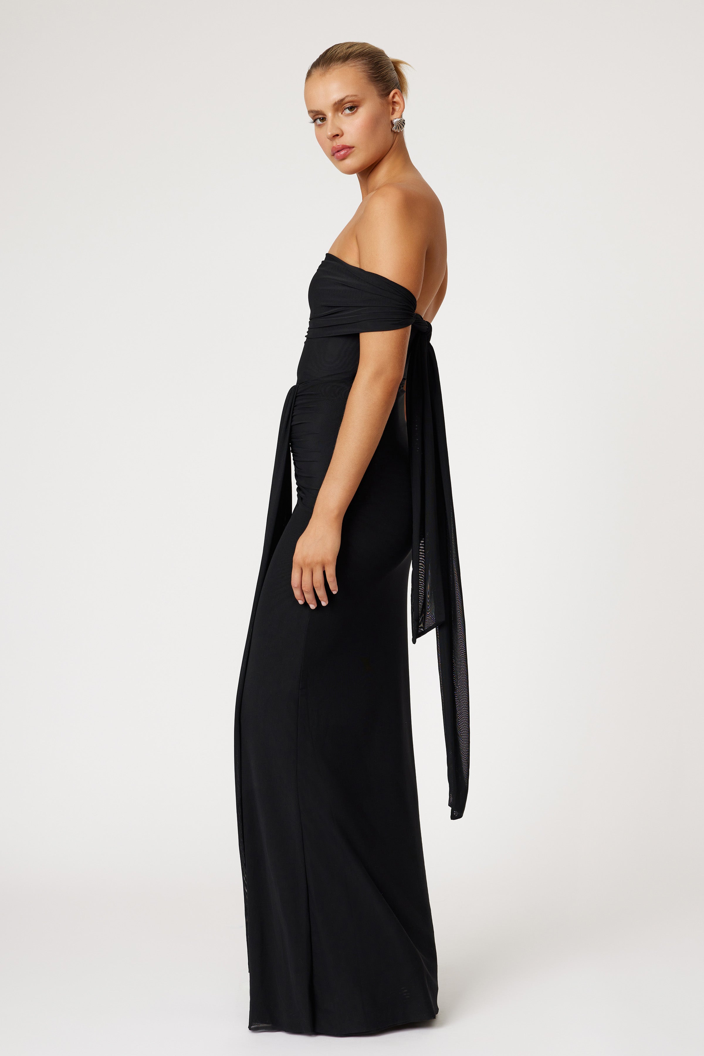 Jora Dress elegant off-shoulder silhouette with draped sleeve detail in black for formal black tie and wedding guest events