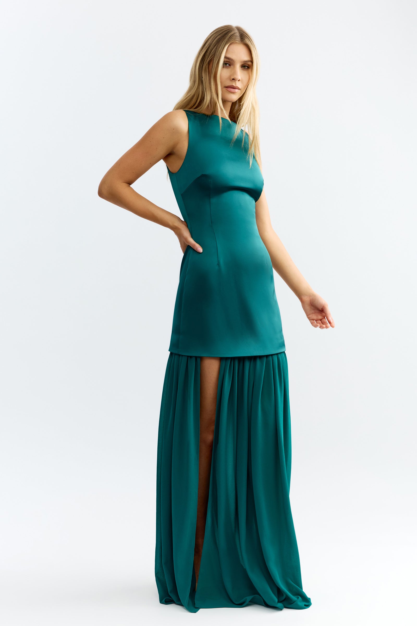 Julia Dress featuring sleeveless design with fitted bodice and flowing skirt with side split in emerald green by Studio Lexi
