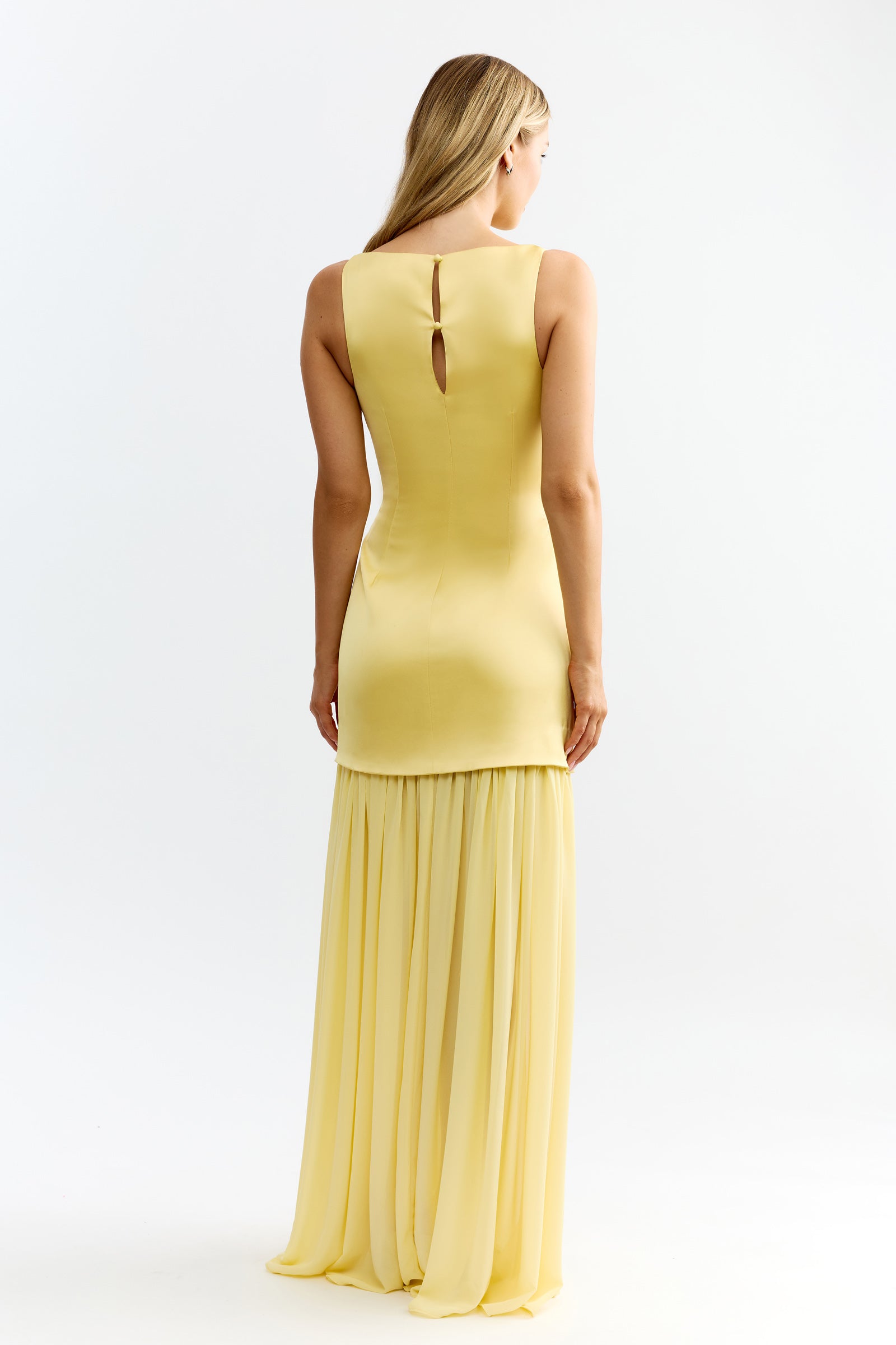 Julia Dress featuring back keyhole detail and flowing skirt in soft sunflower yellow by Studio Lexi