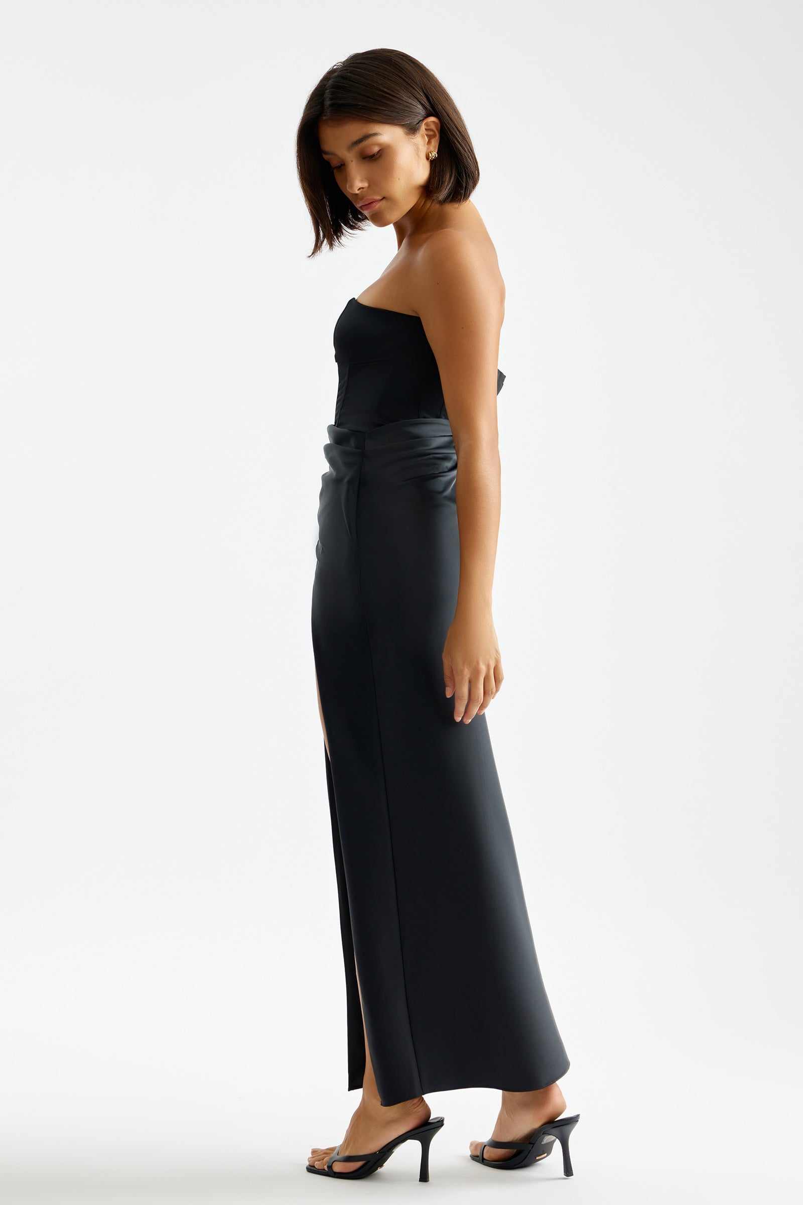 Kaia Dress featuring a strapless silhouette with high slit and sleek black fabric for formal and cocktail occasions by Studio Lexi