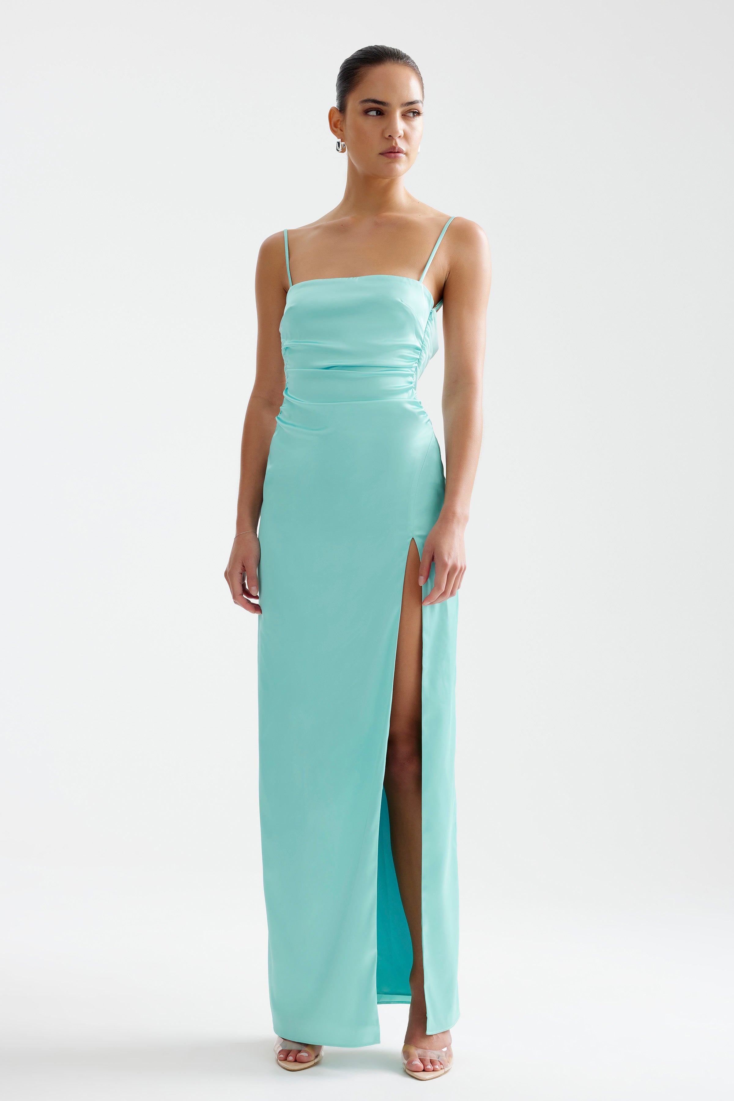 Kiri Dress featuring a sleek silhouette with thin straps and high split in aqua for formal and bridesmaid events by Studio Lexi