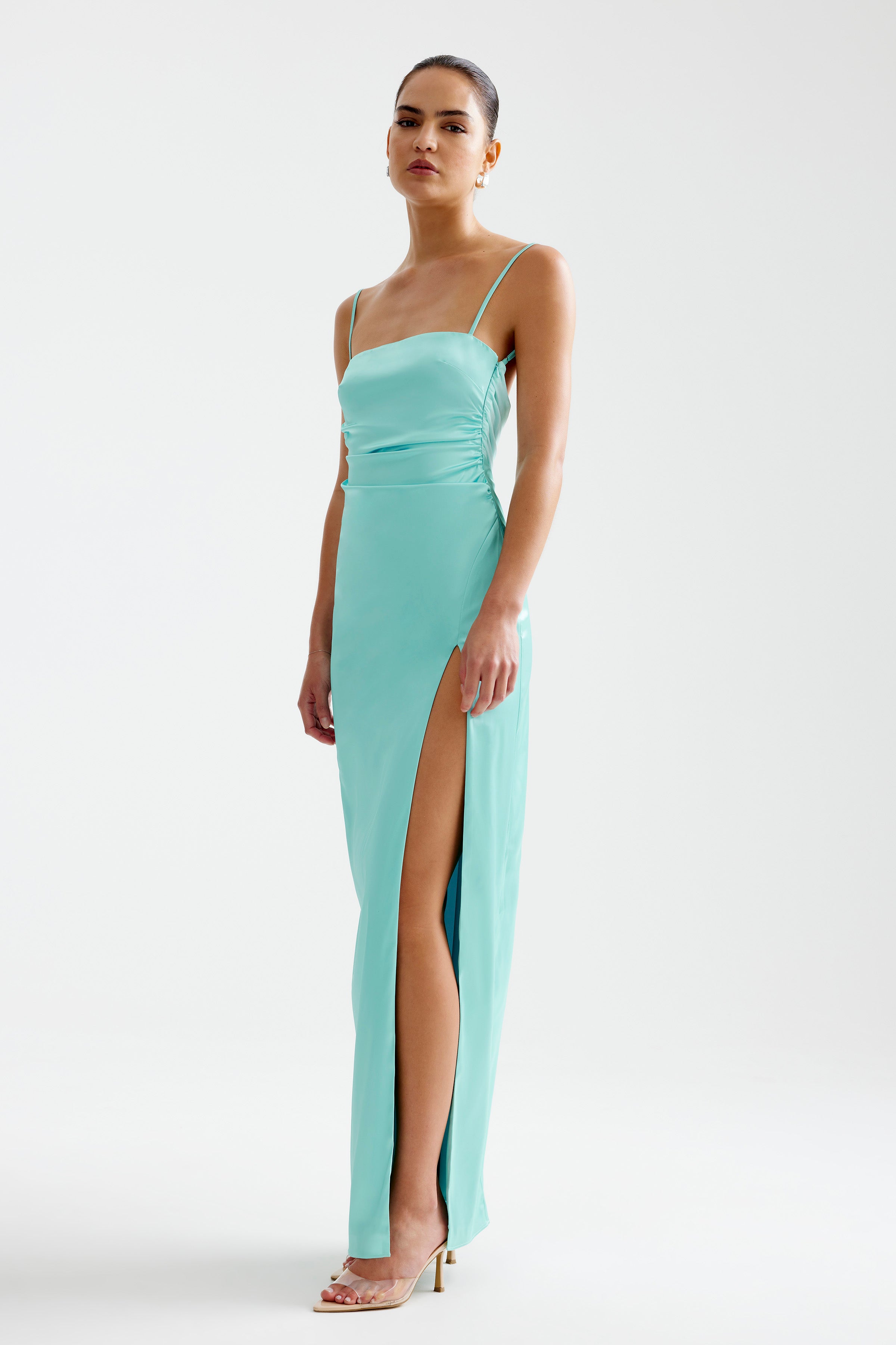Kiri Dress featuring a sleek silhouette with thin straps and a thigh-high split in aqua for formal occasions by Studio Lexi