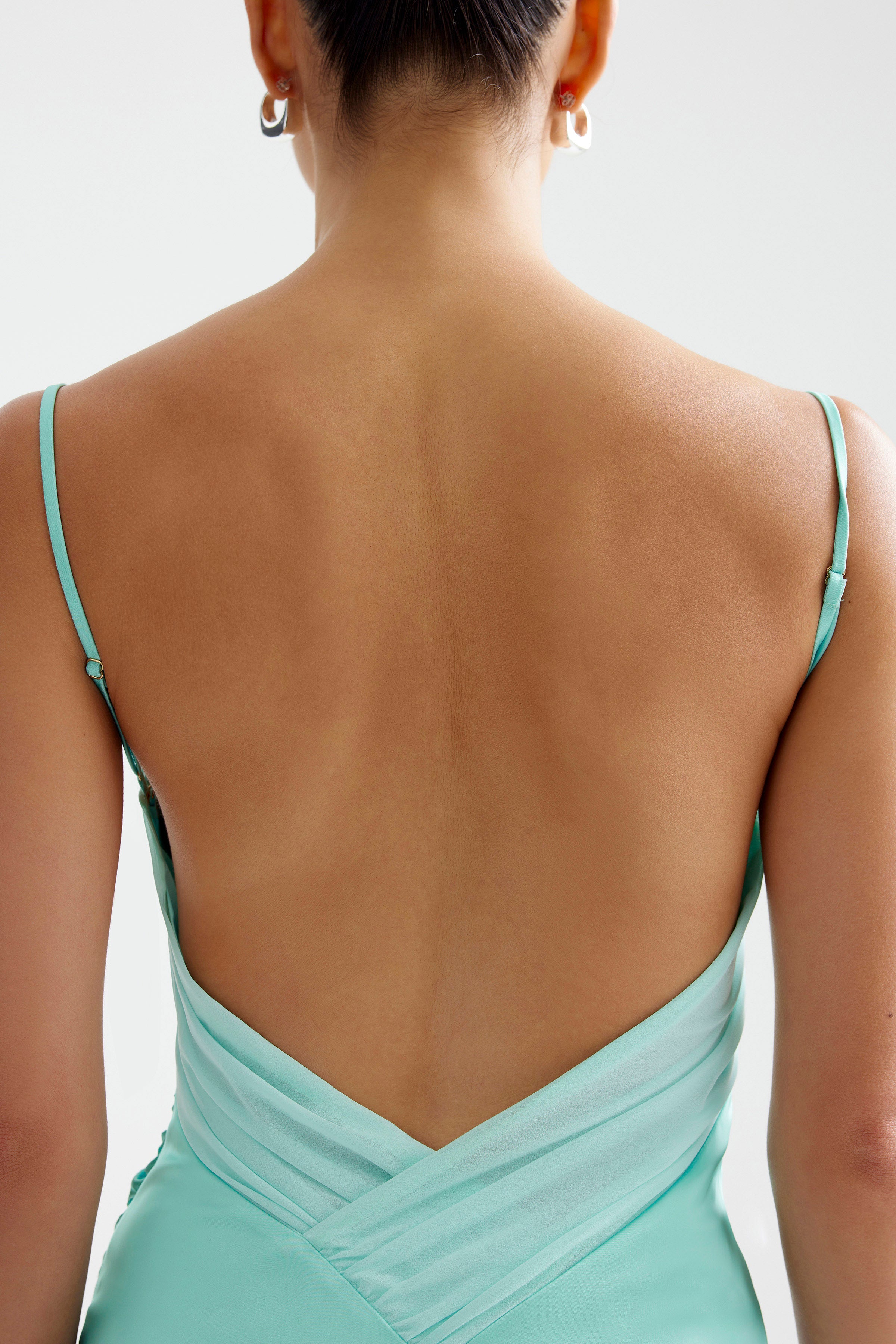 Kiri Dress featuring a backless design with thin adjustable straps in aqua for bridesmaid and formal occasions by Studio Lexi