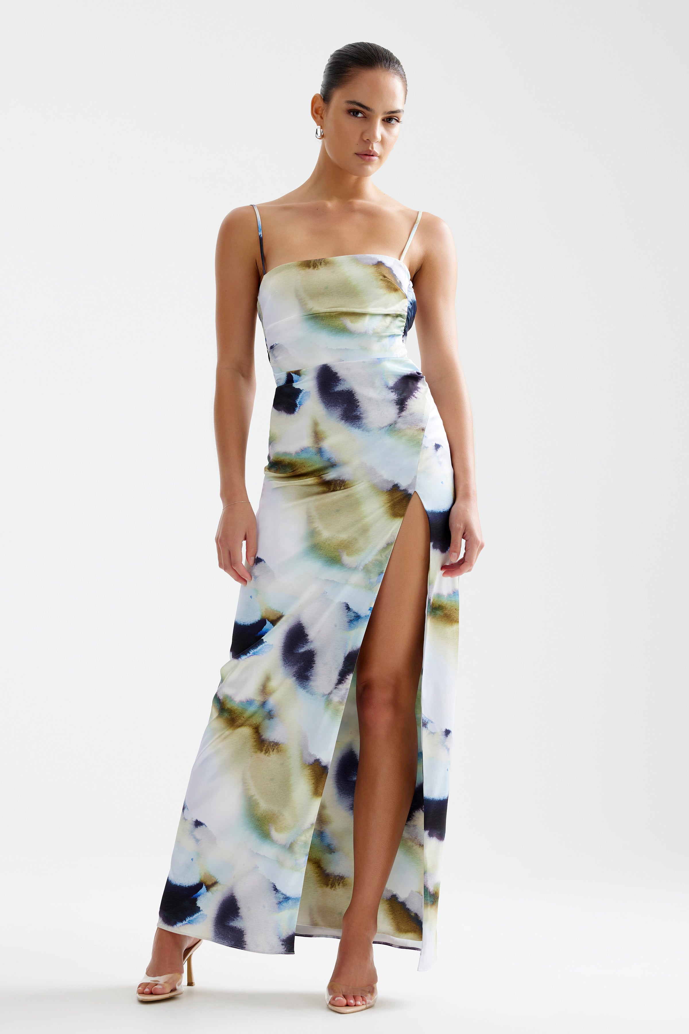 Kiri Dress featuring a backless silhouette with thin straps and high split in blue mineral print for formal events