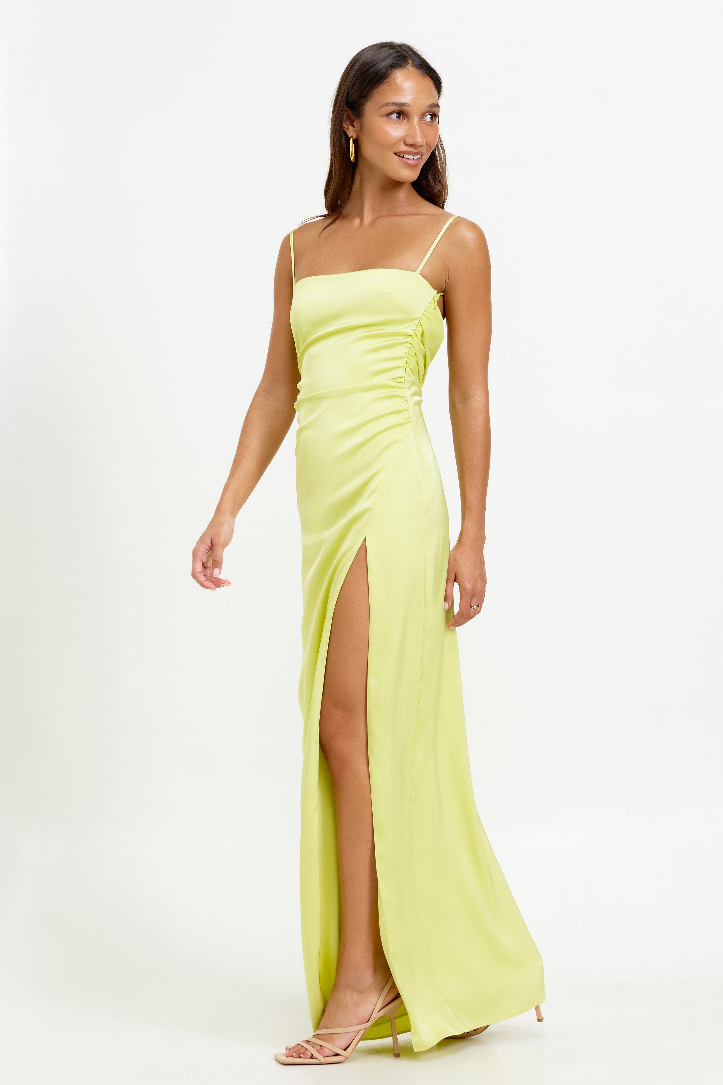 Kiri Dress featuring a slim silhouette with ruched side detailing and a high leg split in mojito green satin for formal occasions