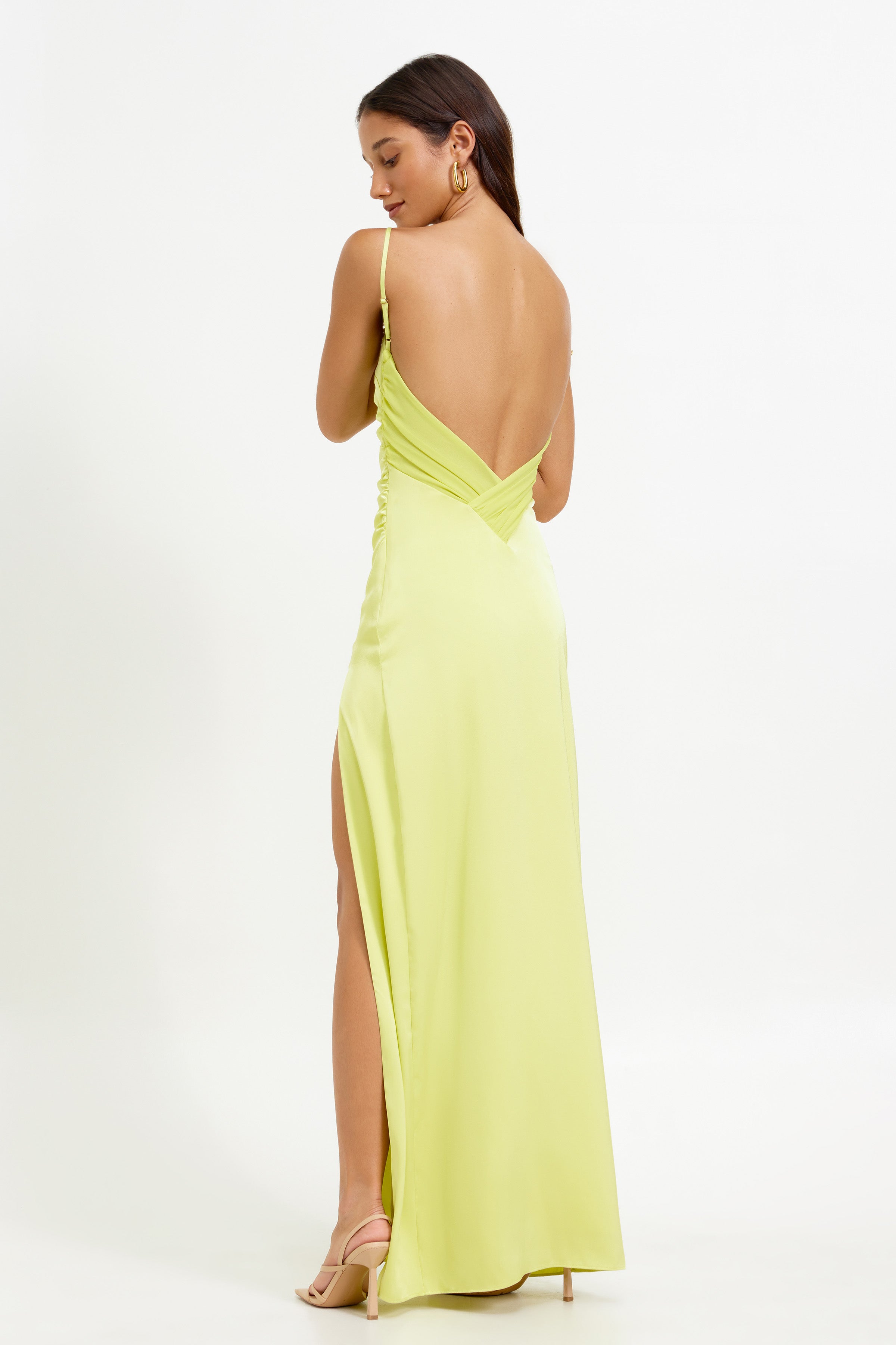 Kiri Dress featuring a backless design with thin straps and a high split in mojito green satin for formal occasions