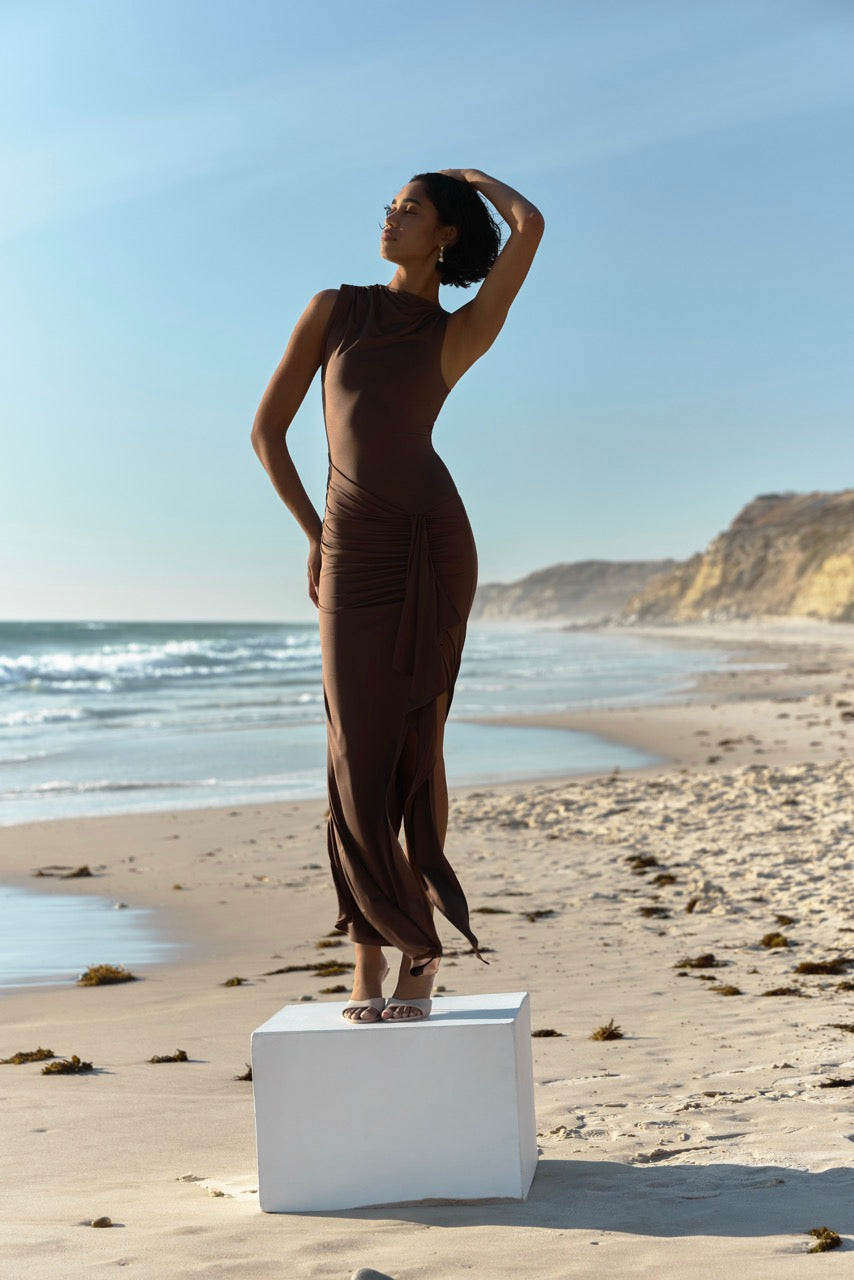 Koda Dress featuring sleeveless design with high neckline and ruched split skirt in chocolate for formal and wedding guest occasions