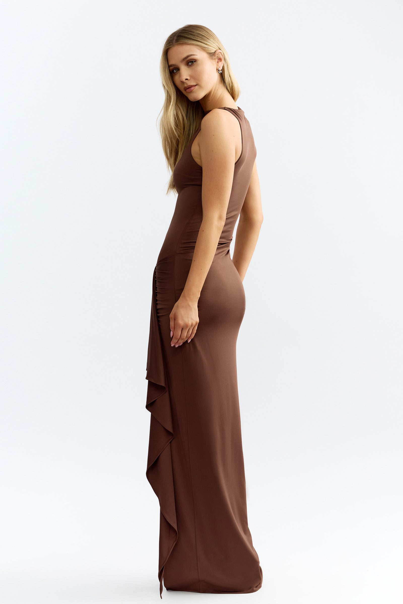 Koda Dress featuring sleeveless silhouette with ruched side and split draped detail in rich chocolate brown by Studio Lexi