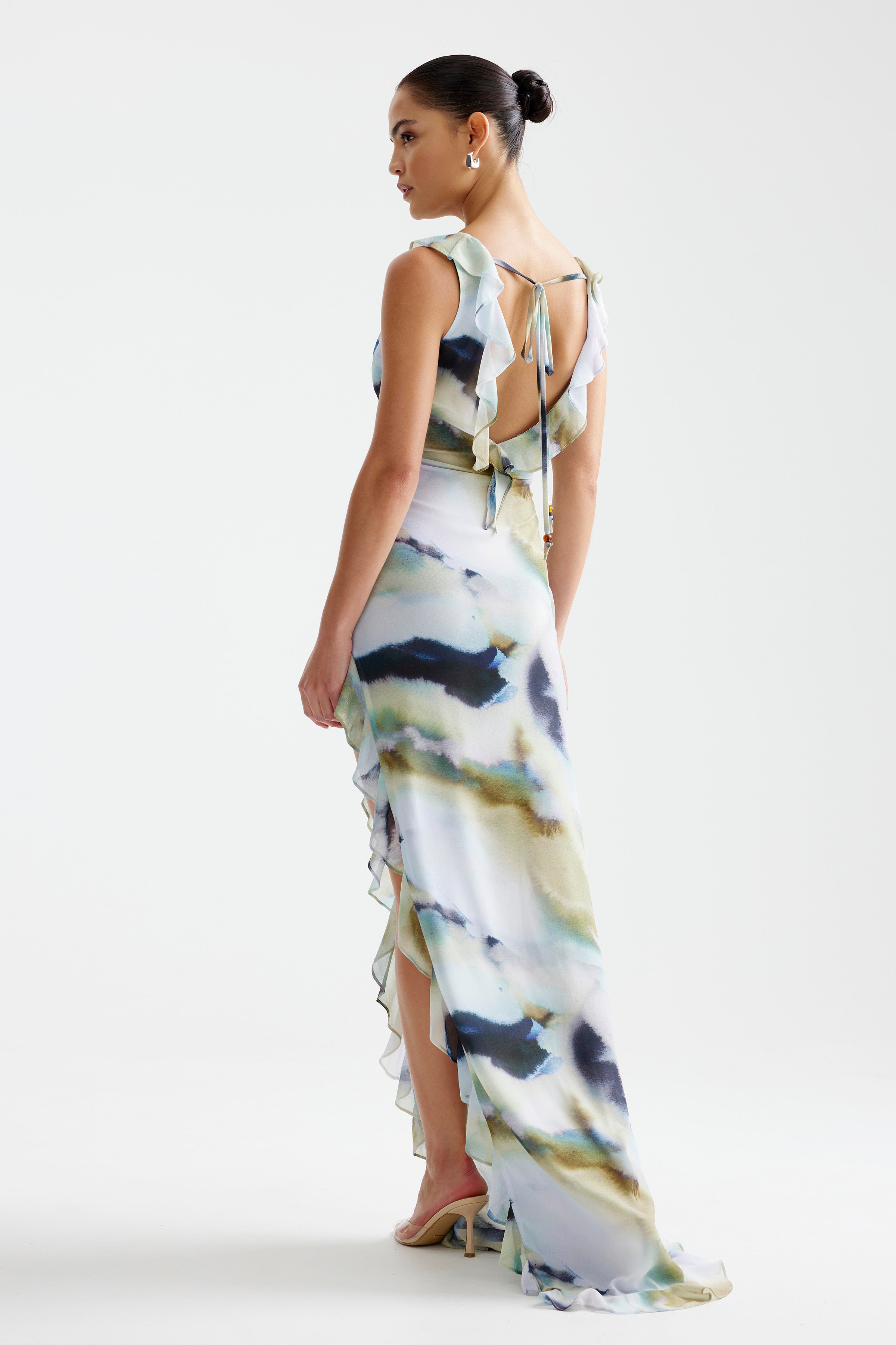 Laguna Dress featuring a ruffled small train, high side split, and open back with tie detail in soft blue mineral print