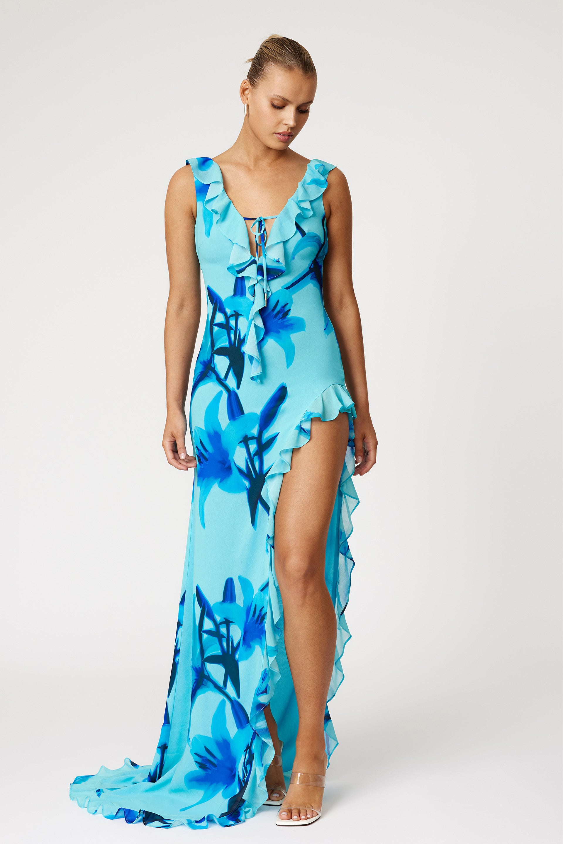 Laguna Dress featuring blue floral print with ruffle trim, high split, and small train for formal and cocktail wear by Studio Lexi