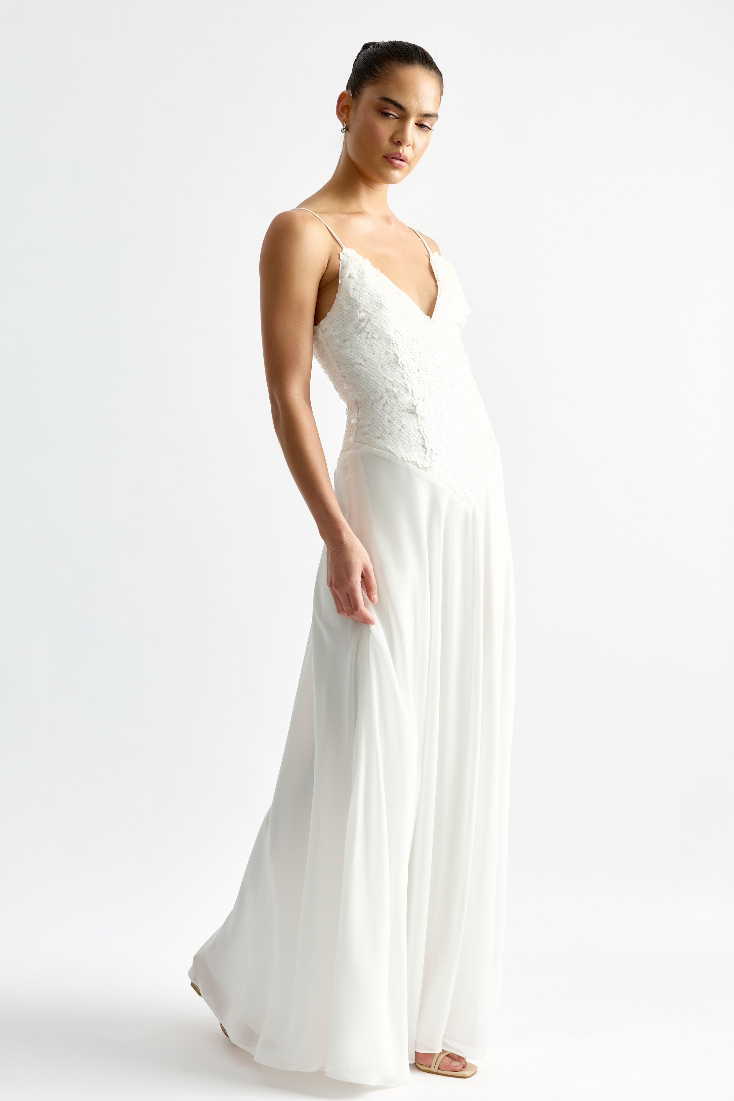 Leandre Dress featuring a lace bodice with thin straps and a flowing chiffon skirt in ivory by Studio Lexi